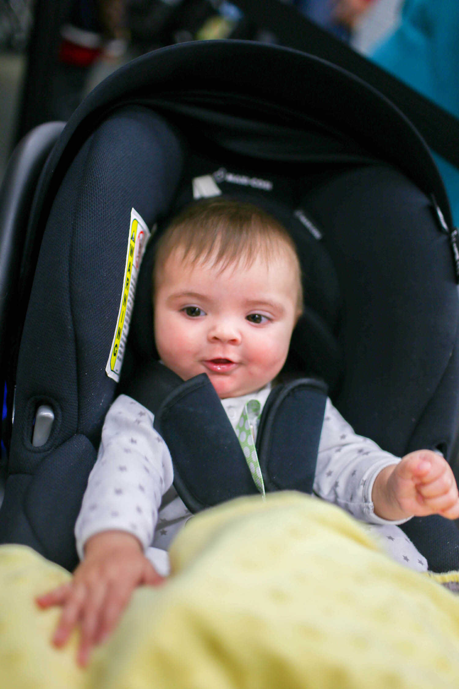 Happy baby Scout in her Maxi-Cosi Zelia travel carseat.