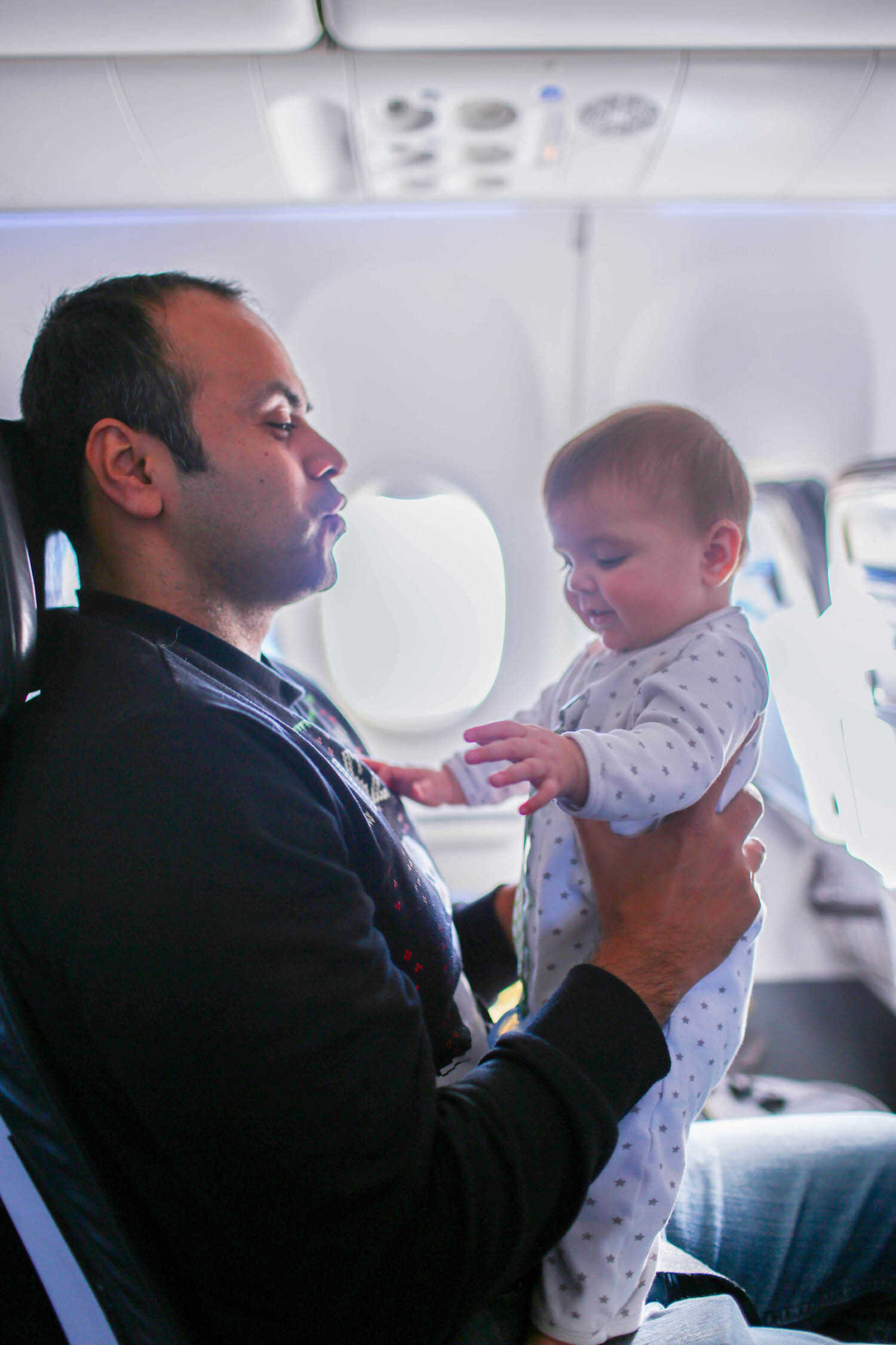 Daddy keeping baby Scout entertained on the airplane.