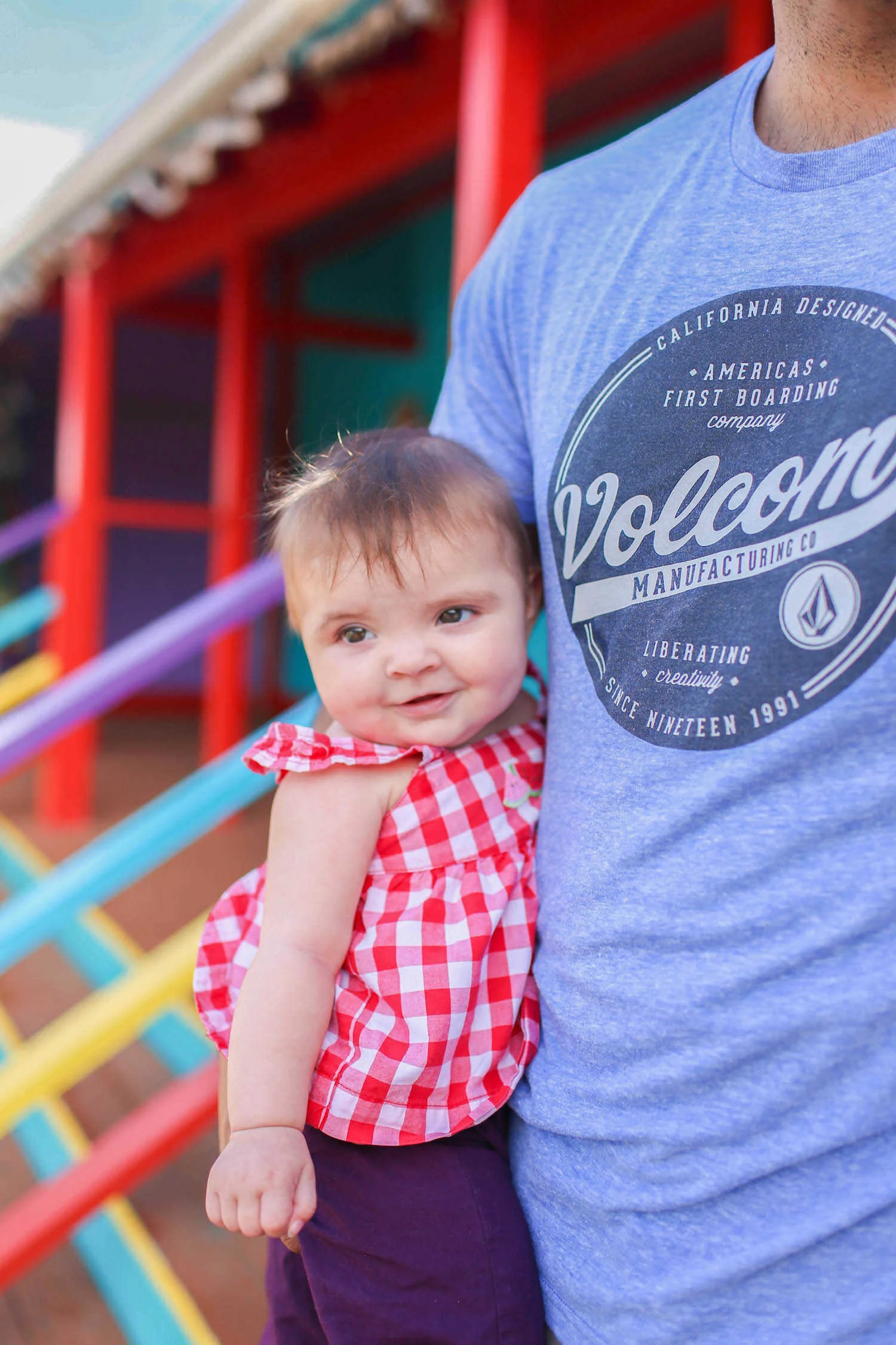 Gennifer Rose - Family Travel Guide to Oahu with a Baby - Father holding happy baby in Oahu, Hawaii.