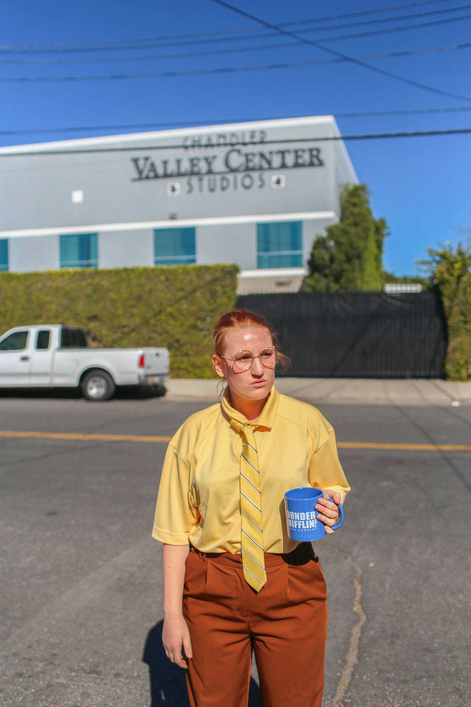 Kara dressed as Dwight Schrute in front of the Dunder Mifflin office building in Panorama City.
