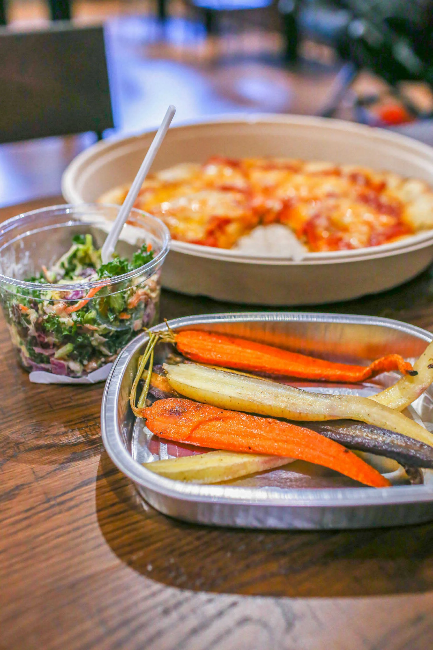 Roasted rainbow carrots, kale salad and pizza from the deli at Raley's O-N-E Market in El Dorado Hills.