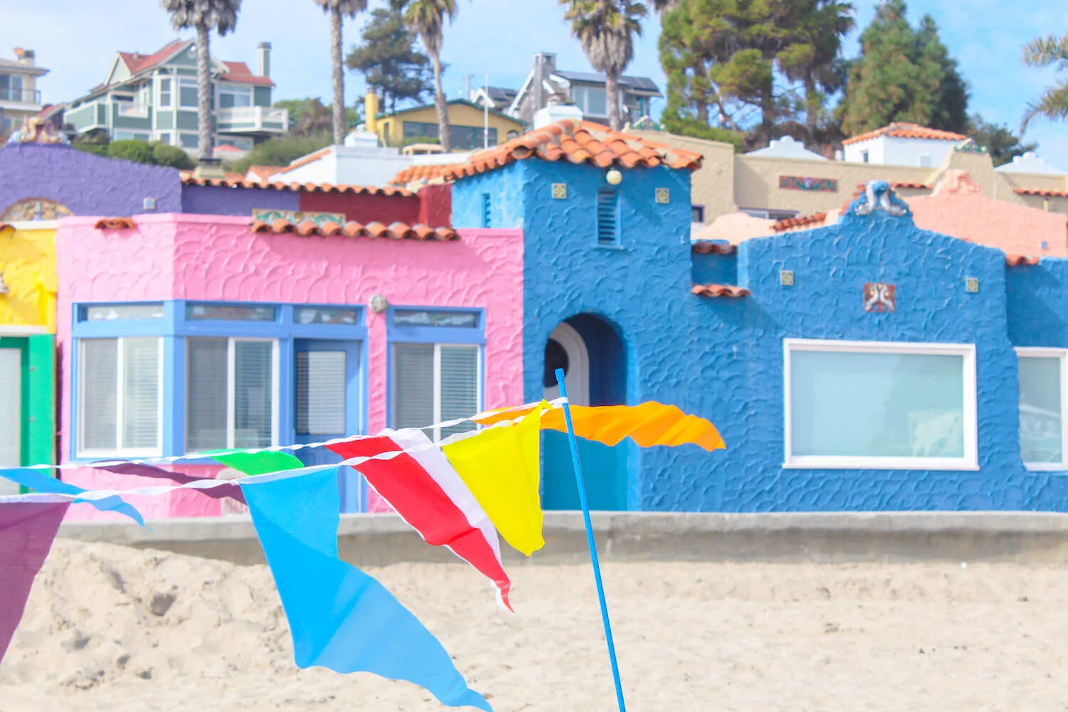Rainbow flags on the sand for beach games at Capitola Beach.