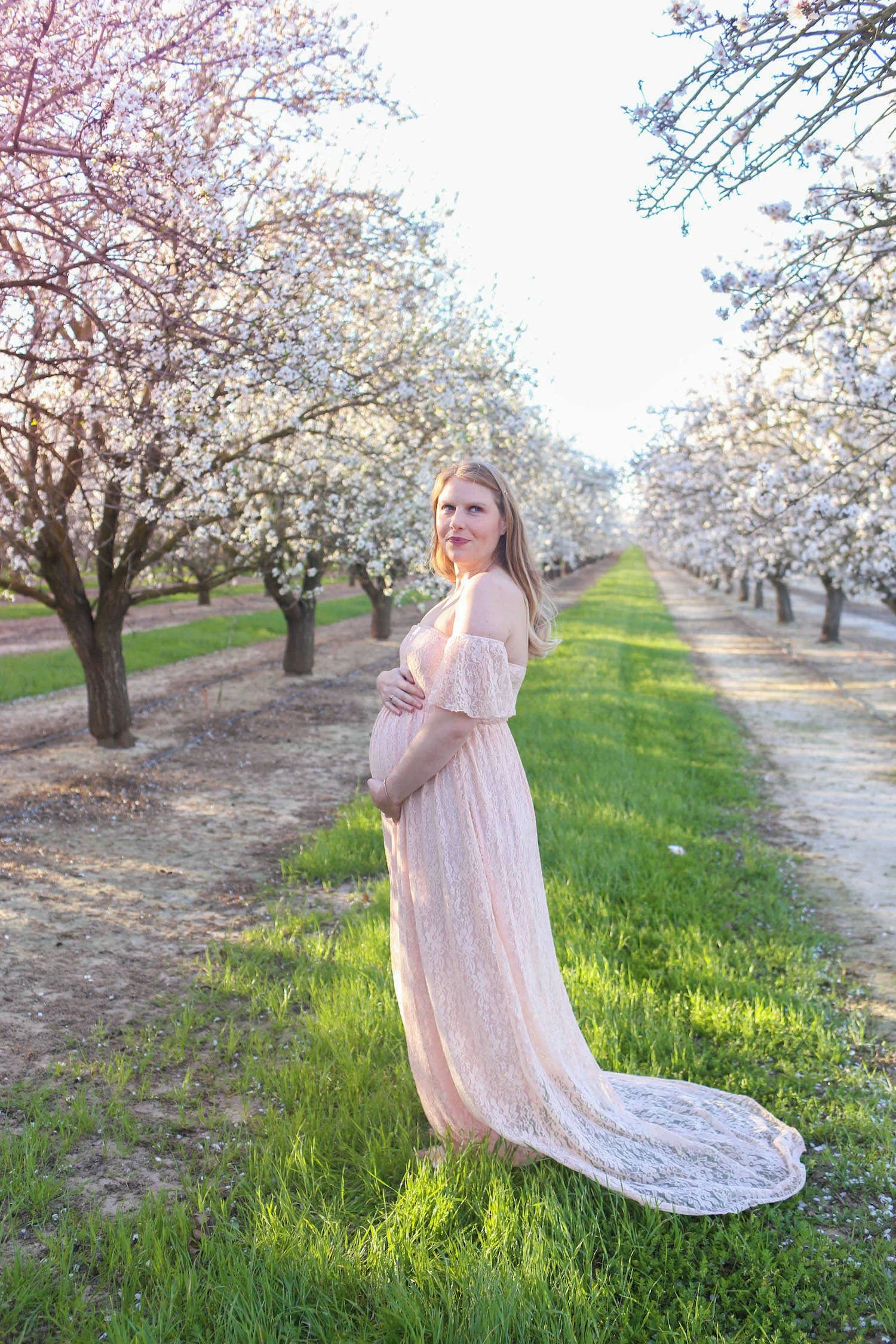 How to Build a Maternity Capsule Wardrobe - Lace maxi gown I wore for a maternity photoshoot at the almond blossoms in Sacramento.