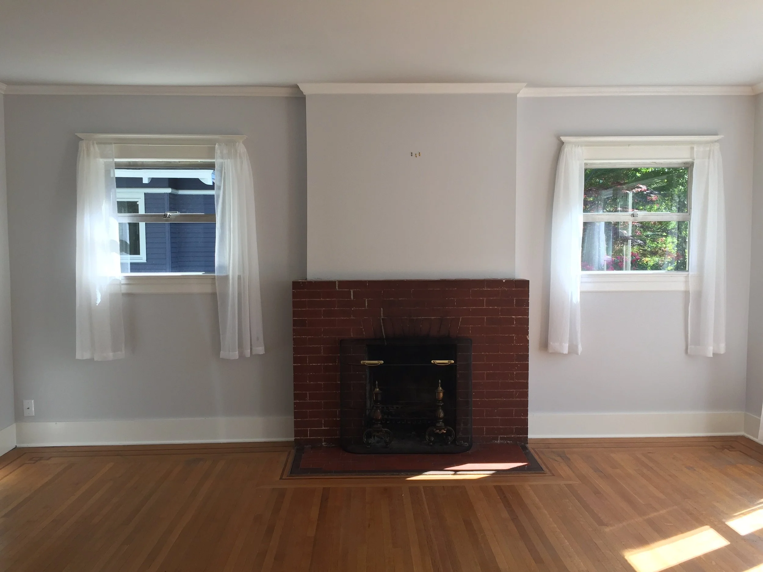 Living room/fireplace — before: Original Capitol Hill Foursquare living room and brick fireplace before renovation