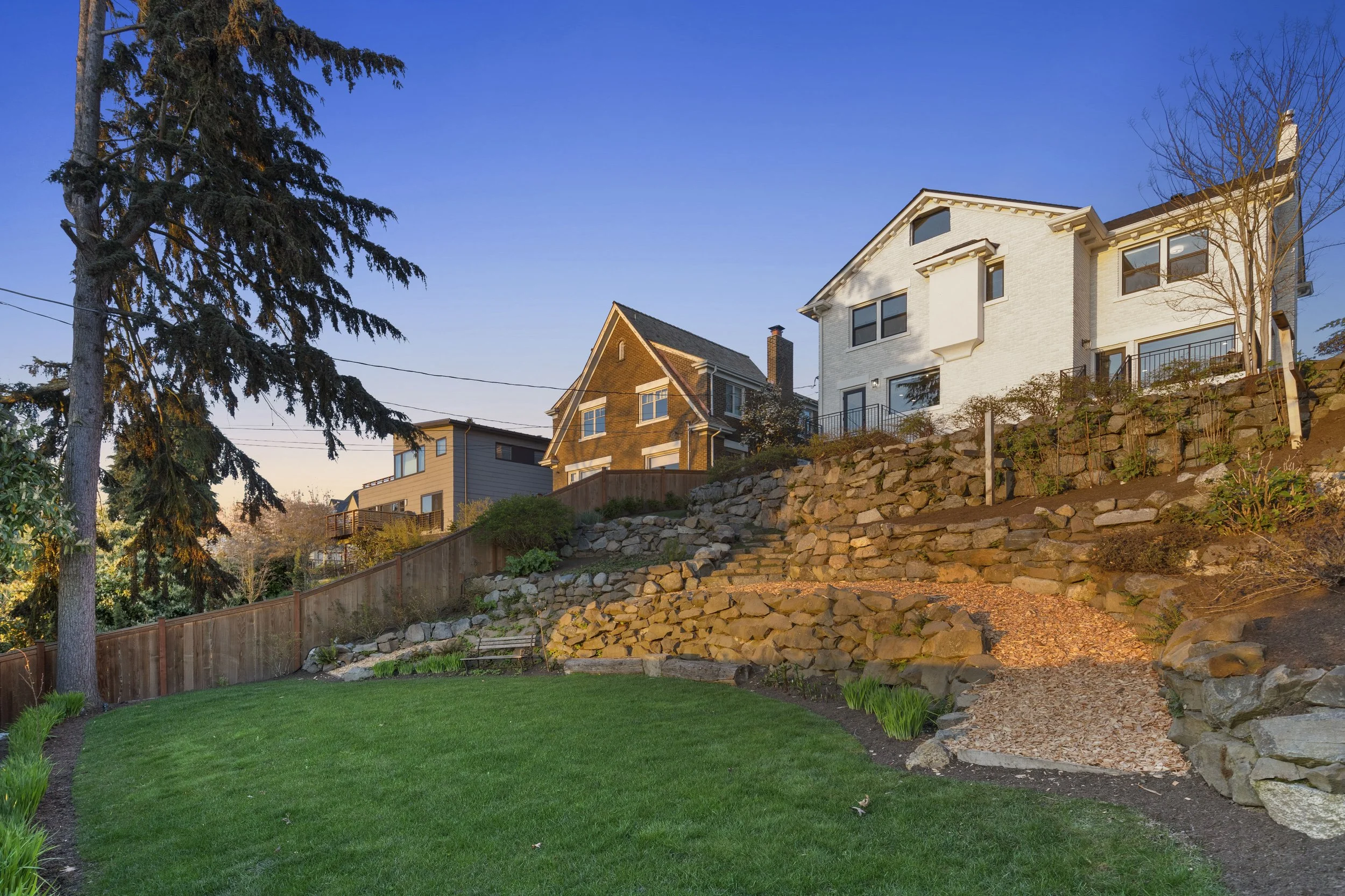 Terraced Backyard with Stone Walls and Garden Paths