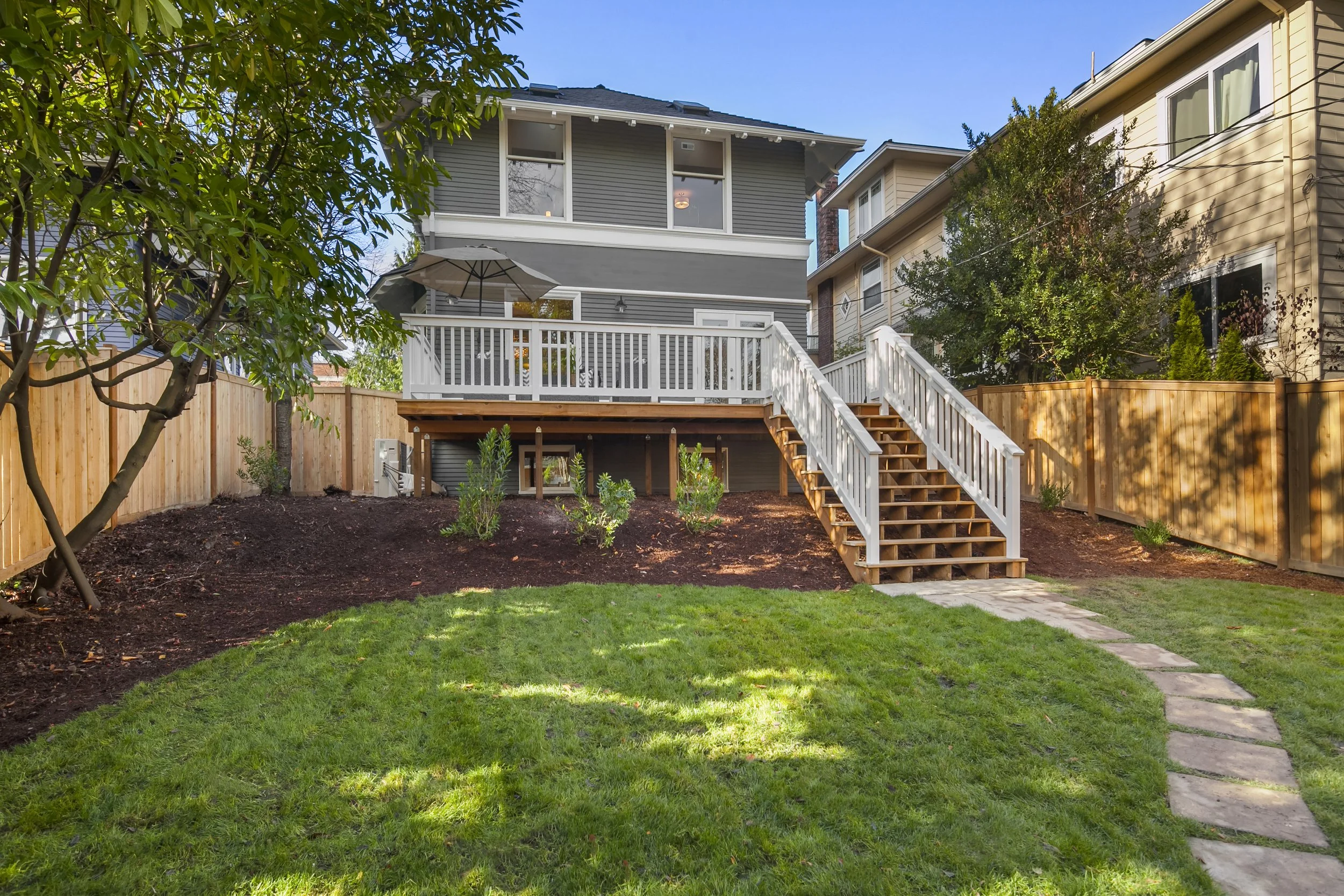 Rear deck — after: Expanded rear deck designed for outdoor dining and entertaining