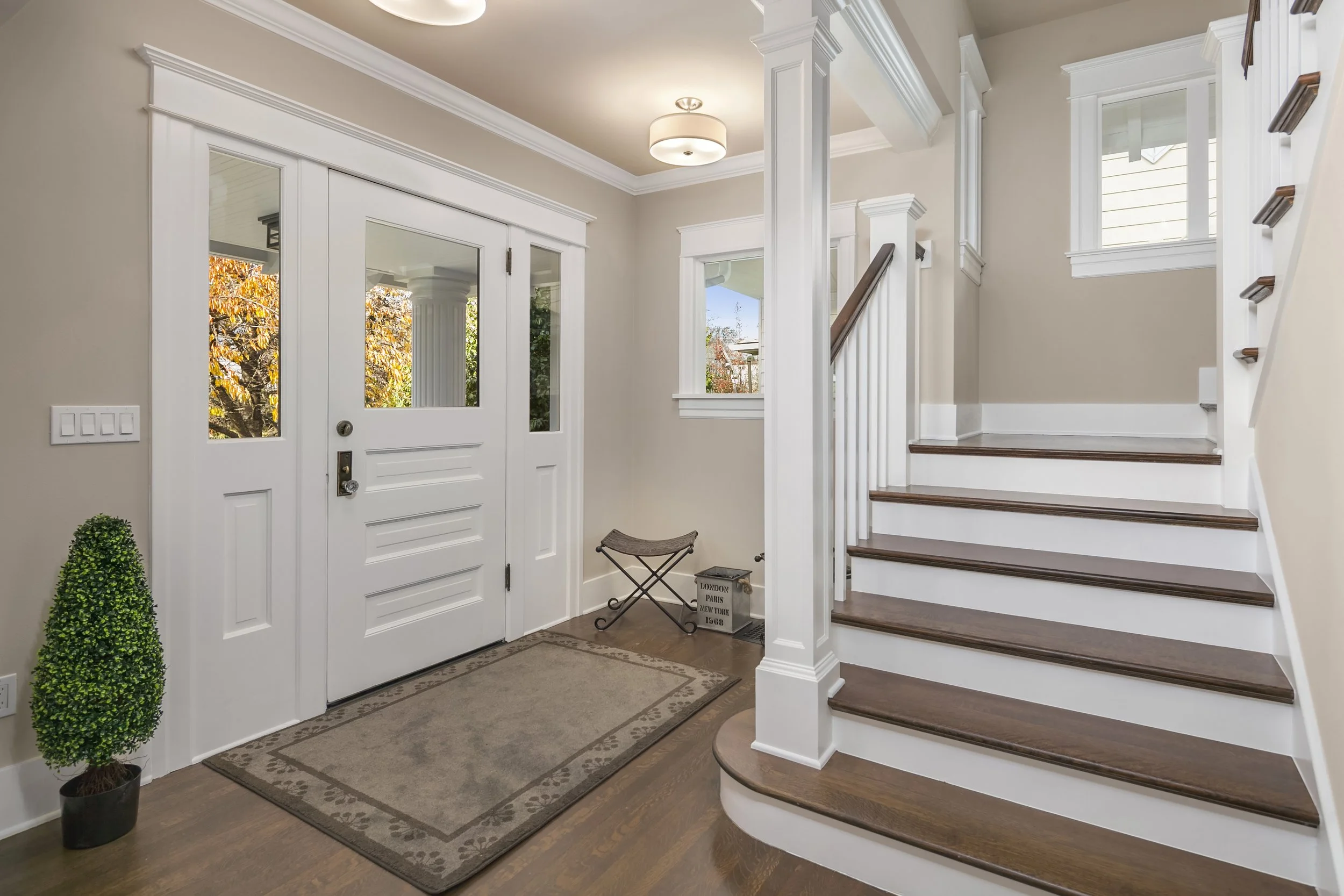 Staircase — after: Restored Foursquare staircase with refinished rounded wood treads