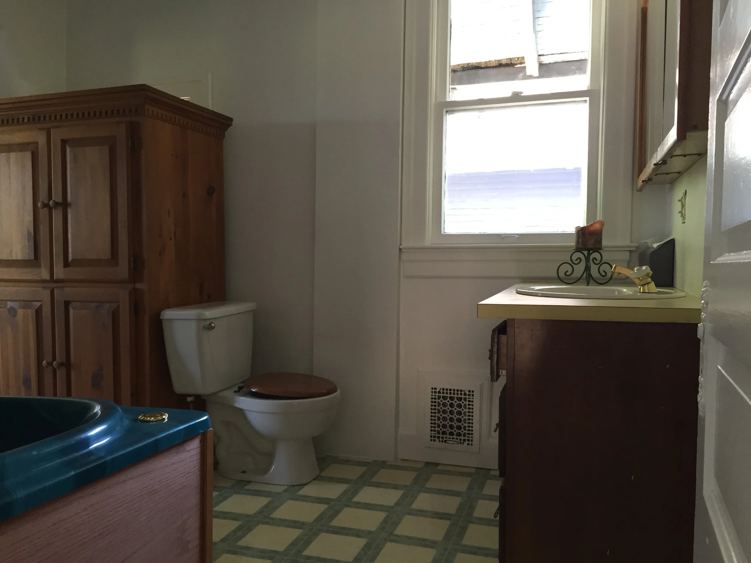 Primary bathroom — before: Original primary bathroom before suite reconfiguration