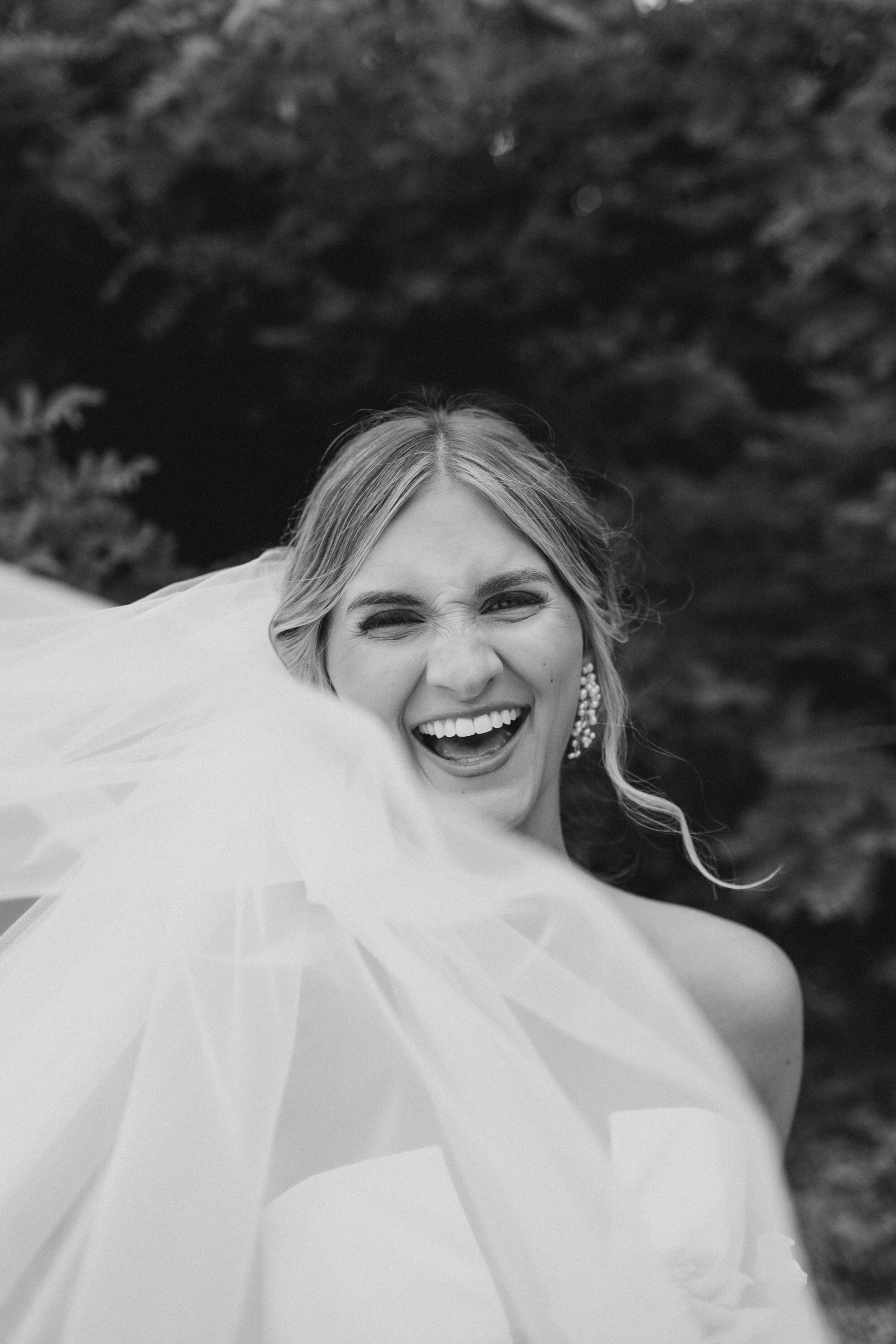  Bride laughs in wedding veil at Mt. Washington Mill Dye House. 