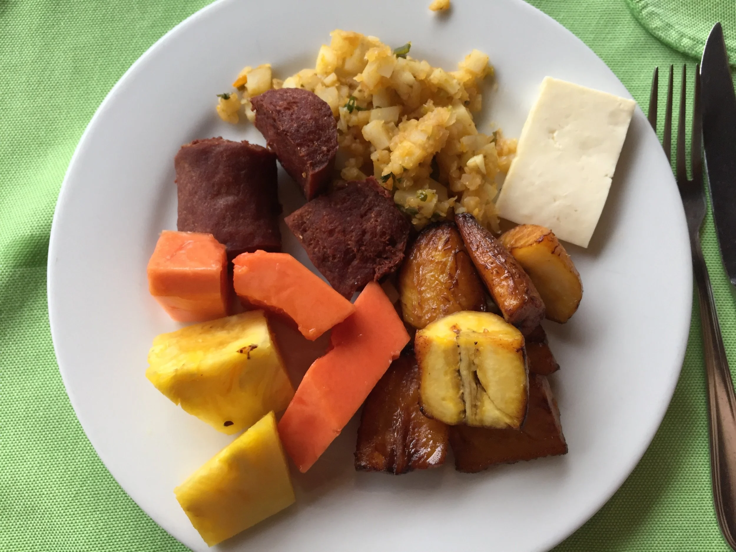 Breakfast: sausage, plantains, queso, fruits