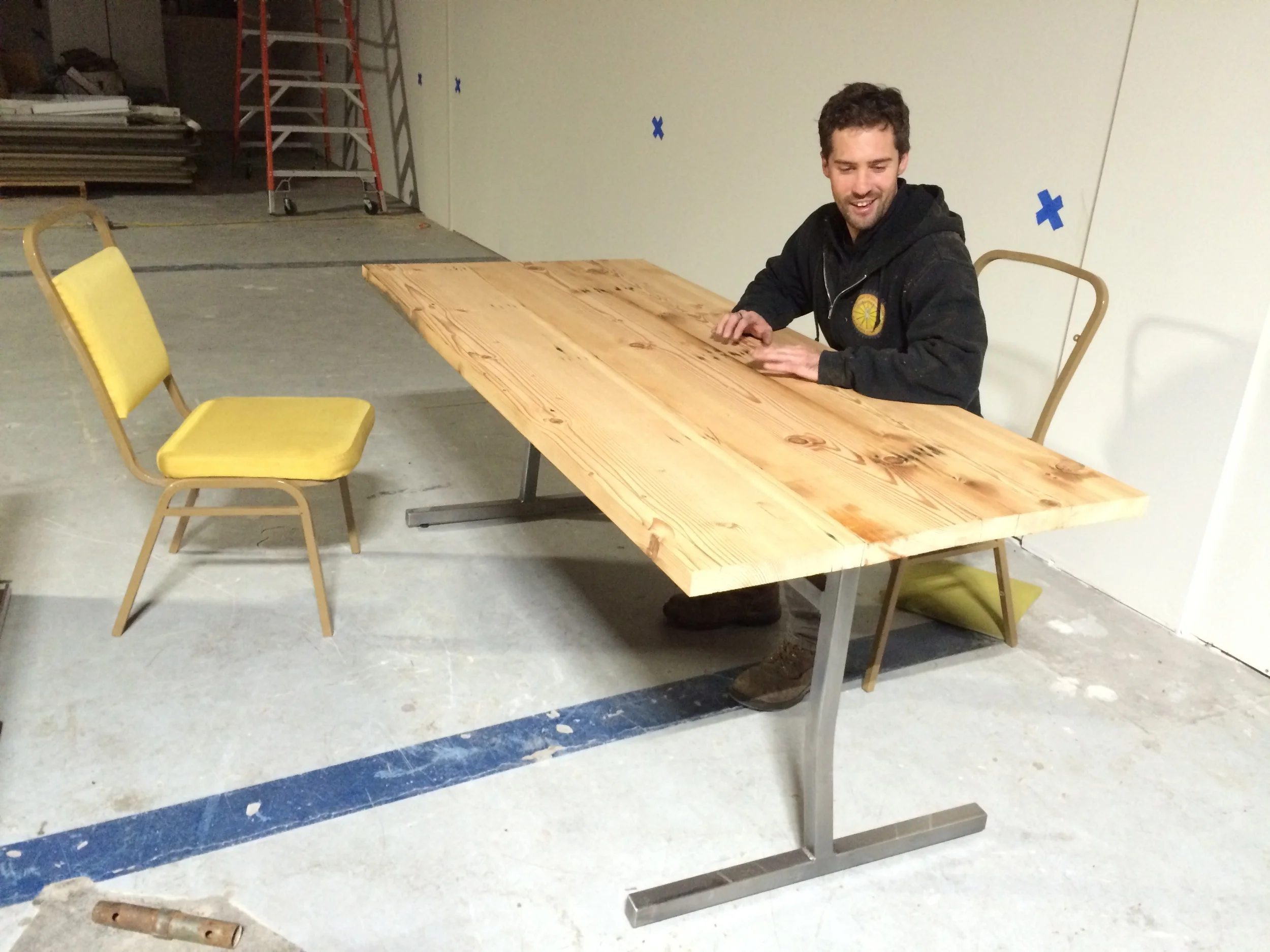Our custom made reclaimed wood and steel tables fabricated by Chimera members, getting a test run and ready for finishing.