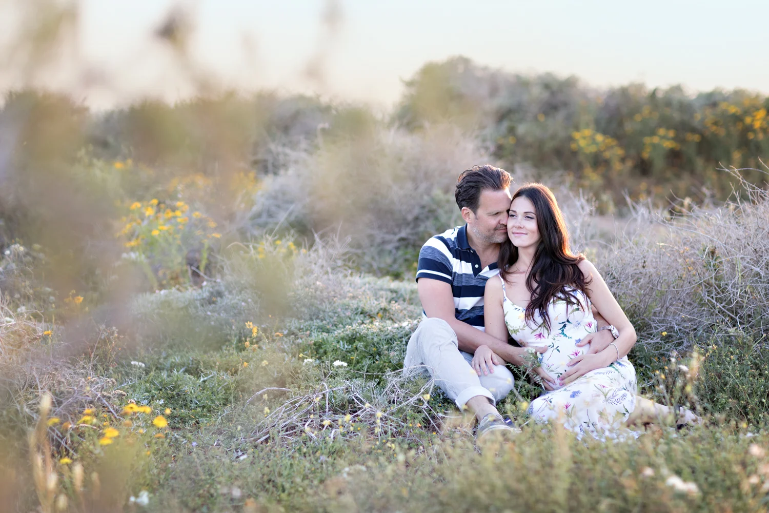 best photographer in malta, portrait photographer malta, maternity photo shoot malta, open field, hugs, emotional