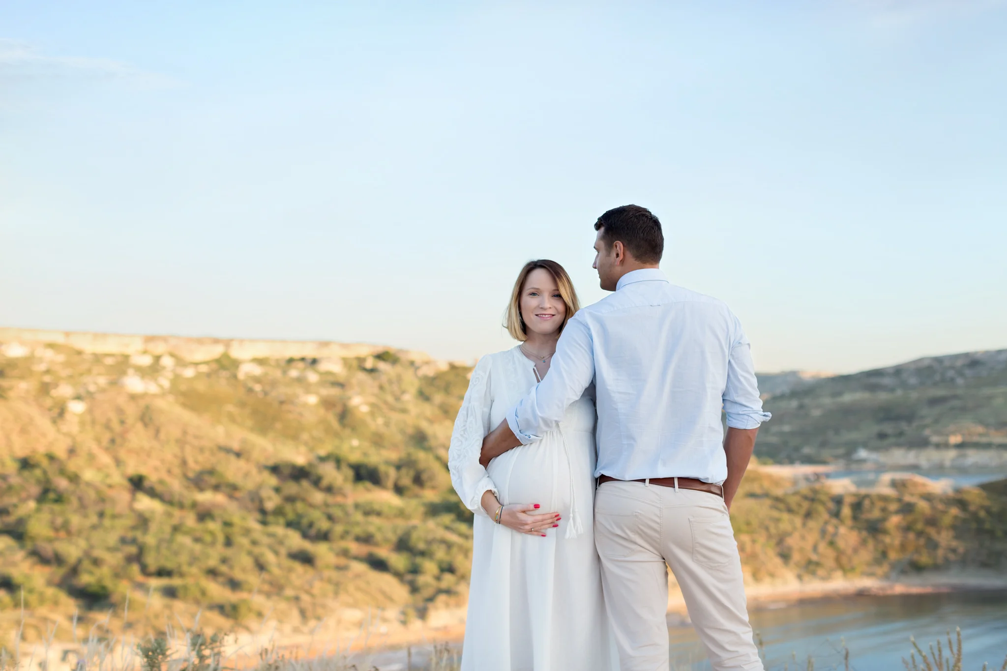 maternity couple, mountain view of golden bay, posing, maternity session malta, boutique photographer, natural light photographer, outdoor photo shoot