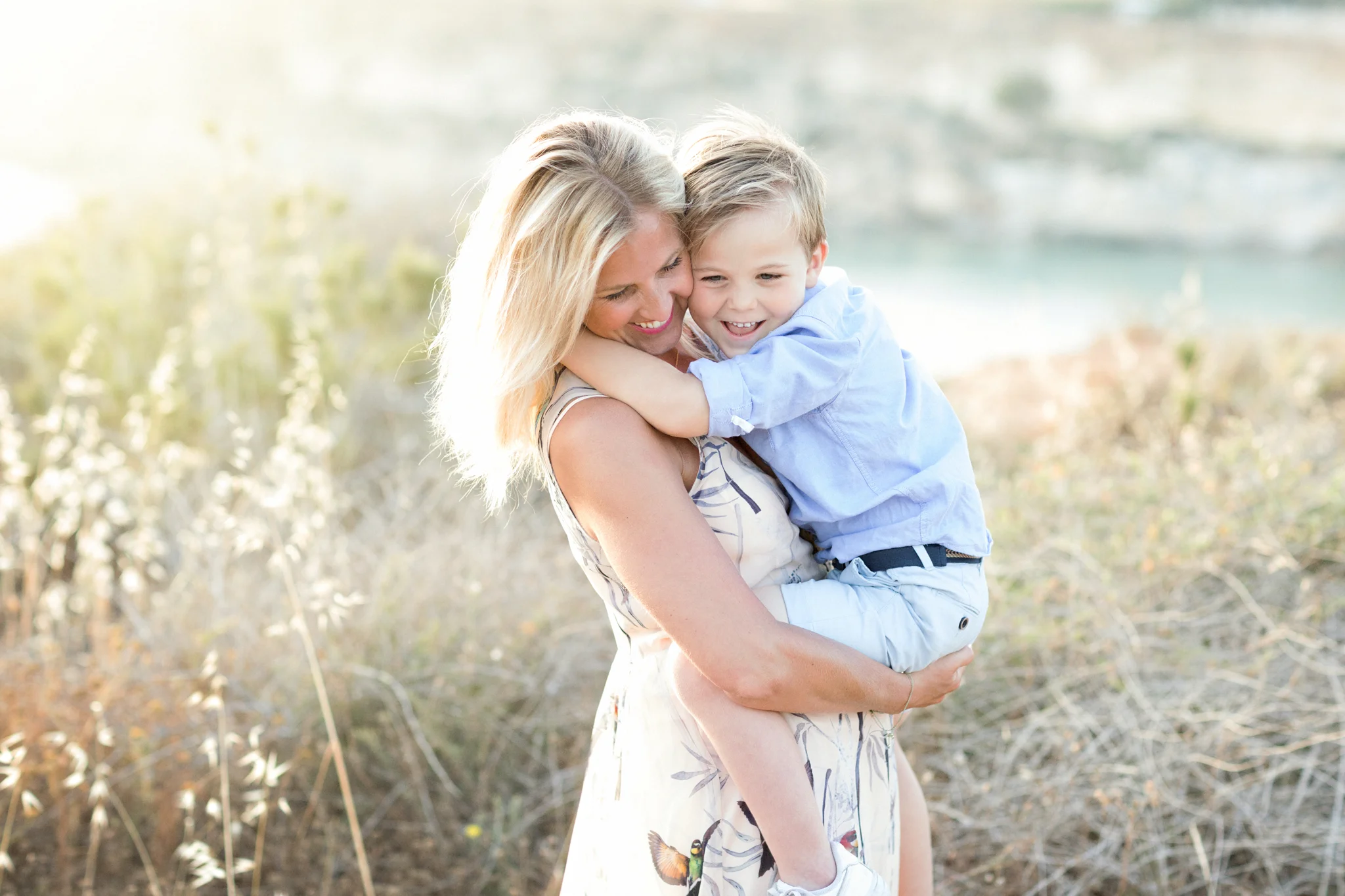 sunset at Riviera Bay, backlight, mother and child, family photography malta, mountains, Mediterranean sea, swedish in malta, best photographer malta, high end photographer malta, cuddles, 