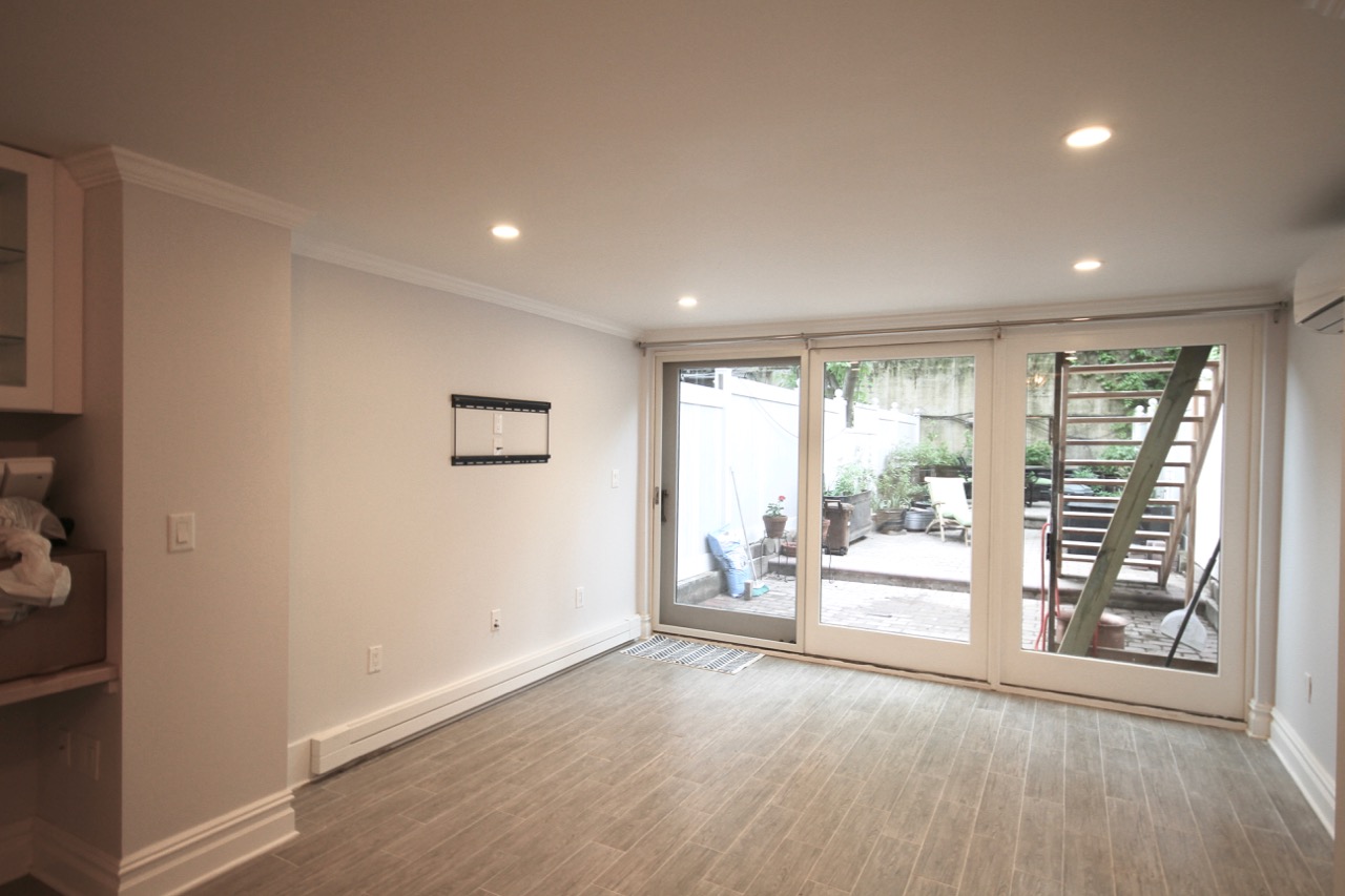 which opens into the living room and floor to ceiling windows that look out on my garden.