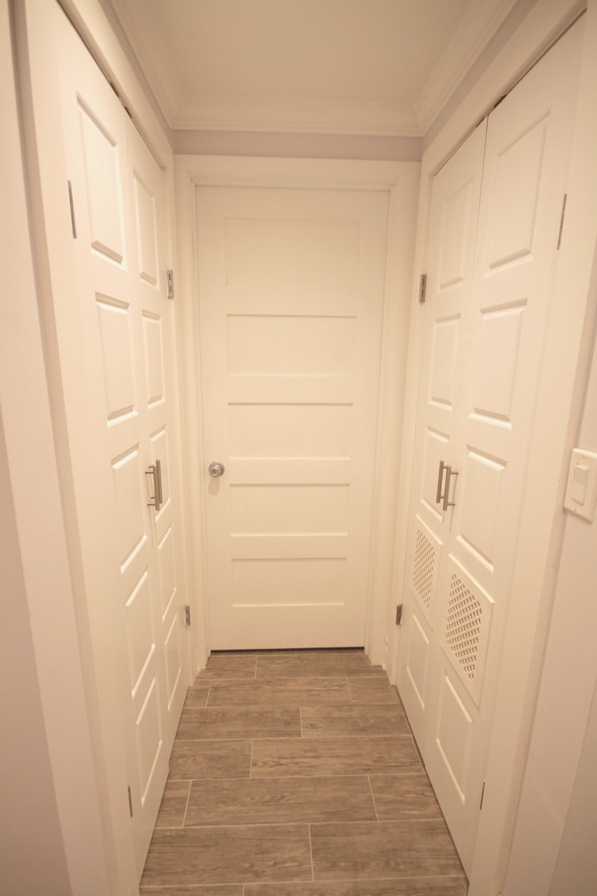 Further down the hall, there is a coat closet, bathroom and laundry center. 