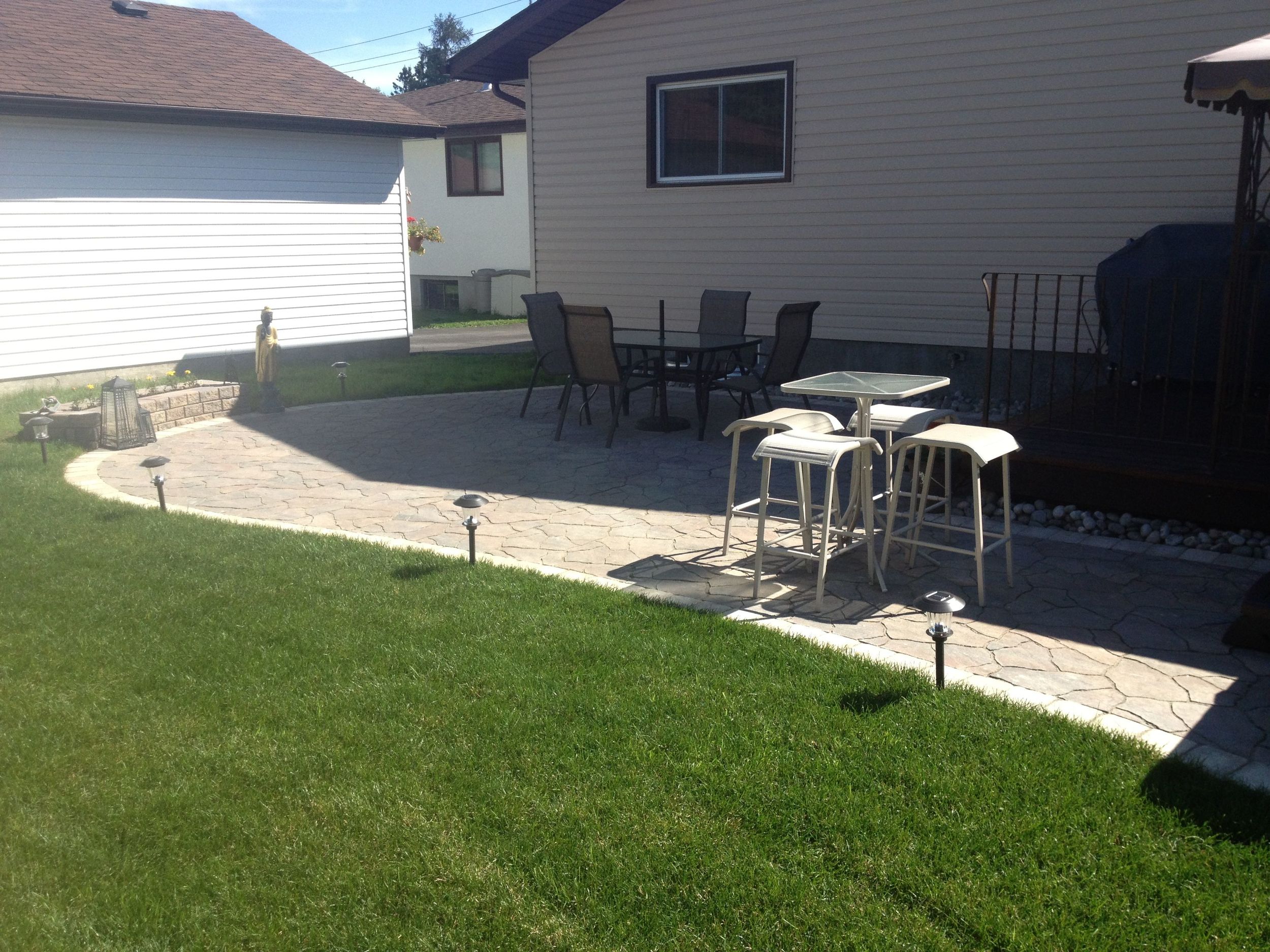  Ask us for the before picture of this yard. New Grading, a new stone patio, a custom flower planter, and new sod transformed the look of this backyard. 
