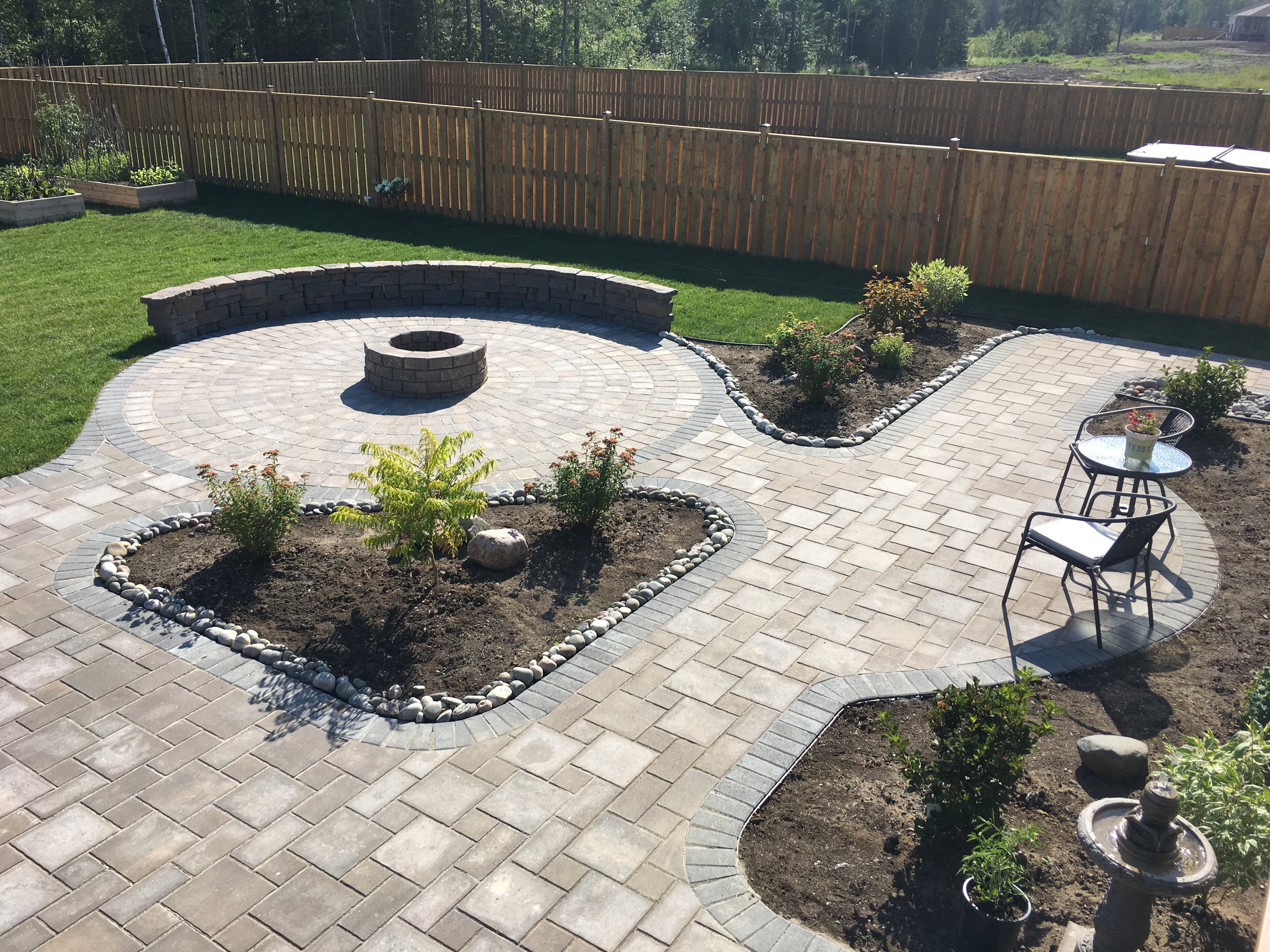 paving stone patio with flower beds/seat wall/fire pit