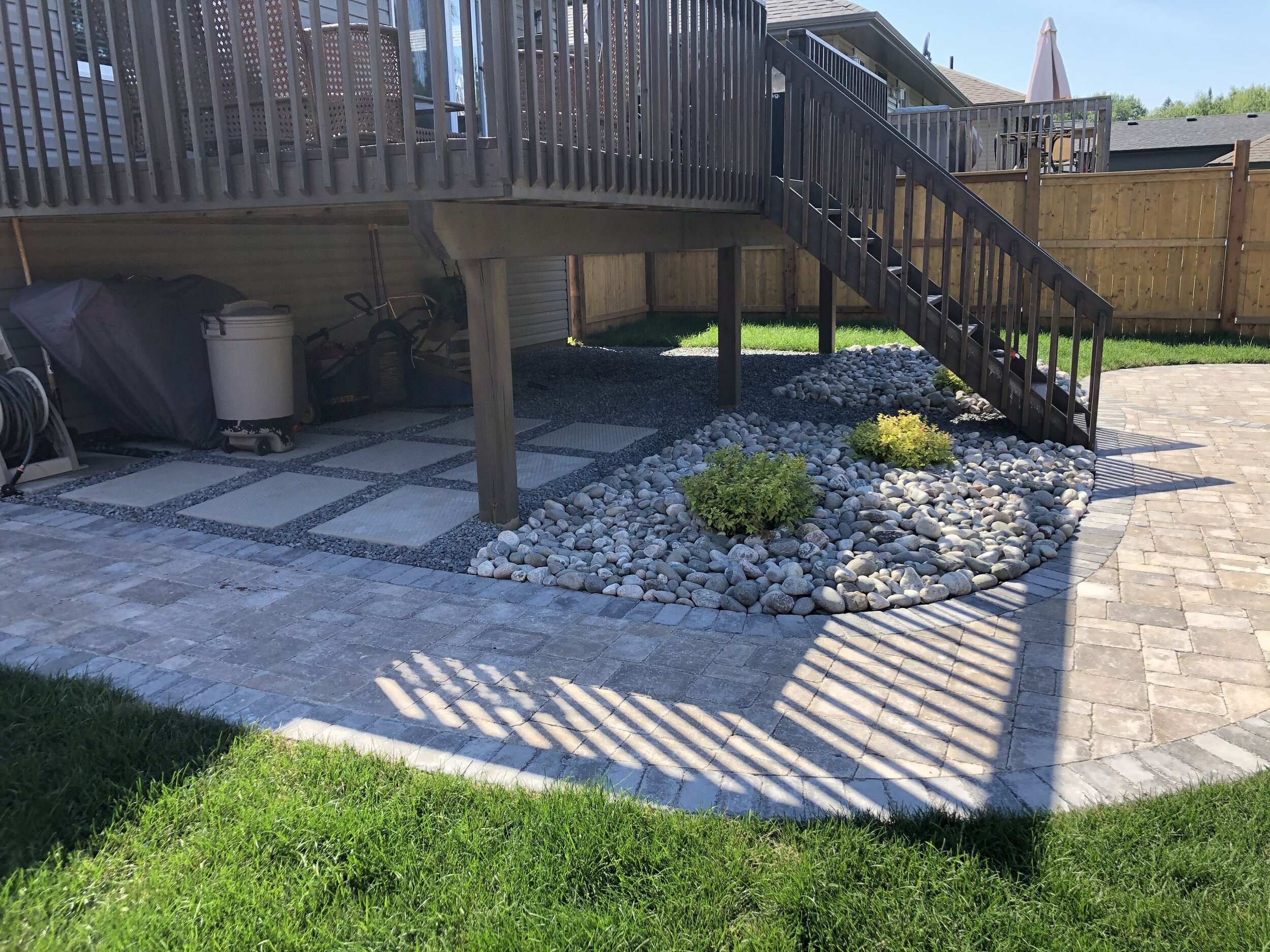 Roman Paver Pathway to a nice clean storage area under the deck and a circle patio 