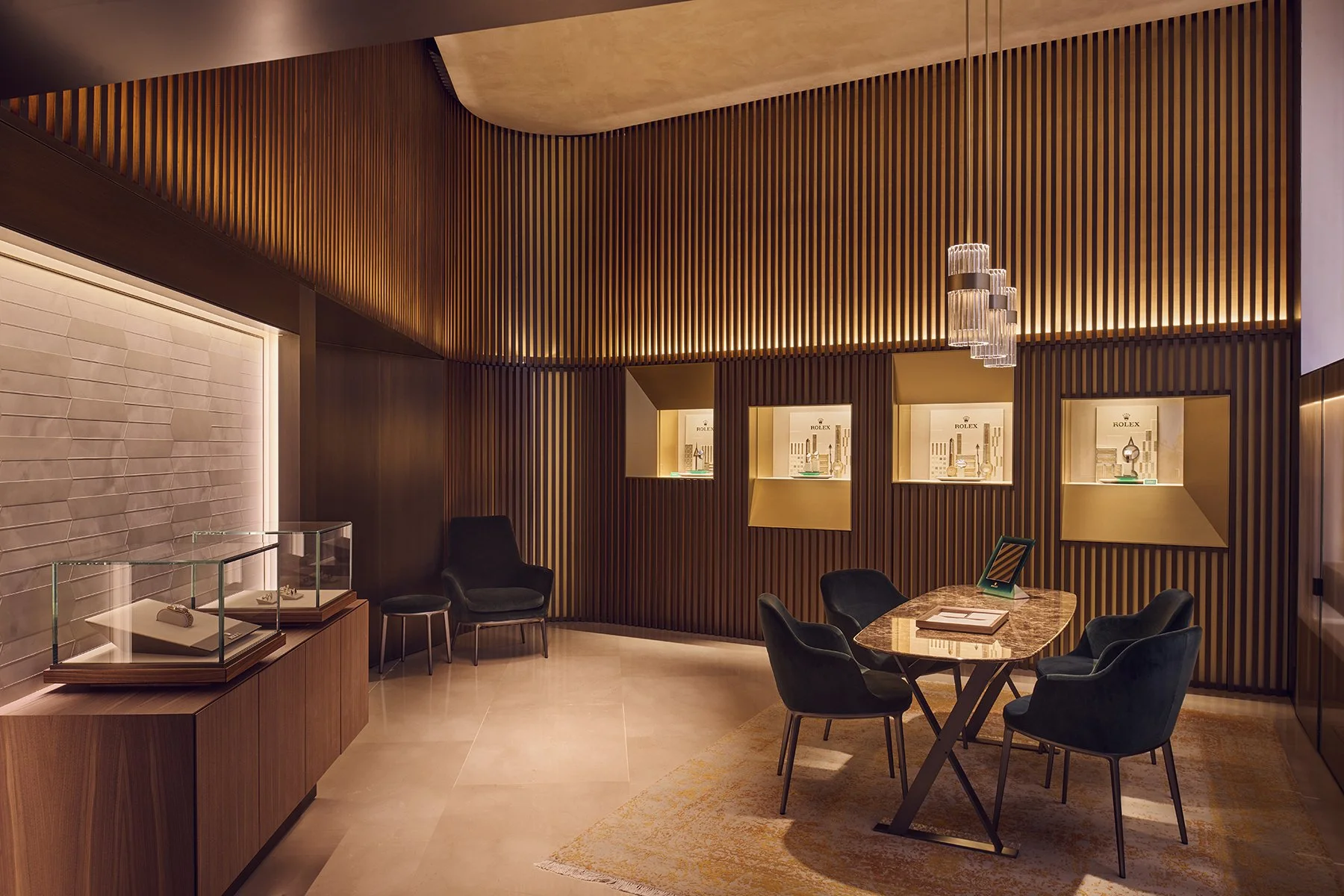 Luxury jewelry store interior with glass display cases, black chairs around a marble table, and wooden slat wall with illuminated display niches showcasing jewelry.