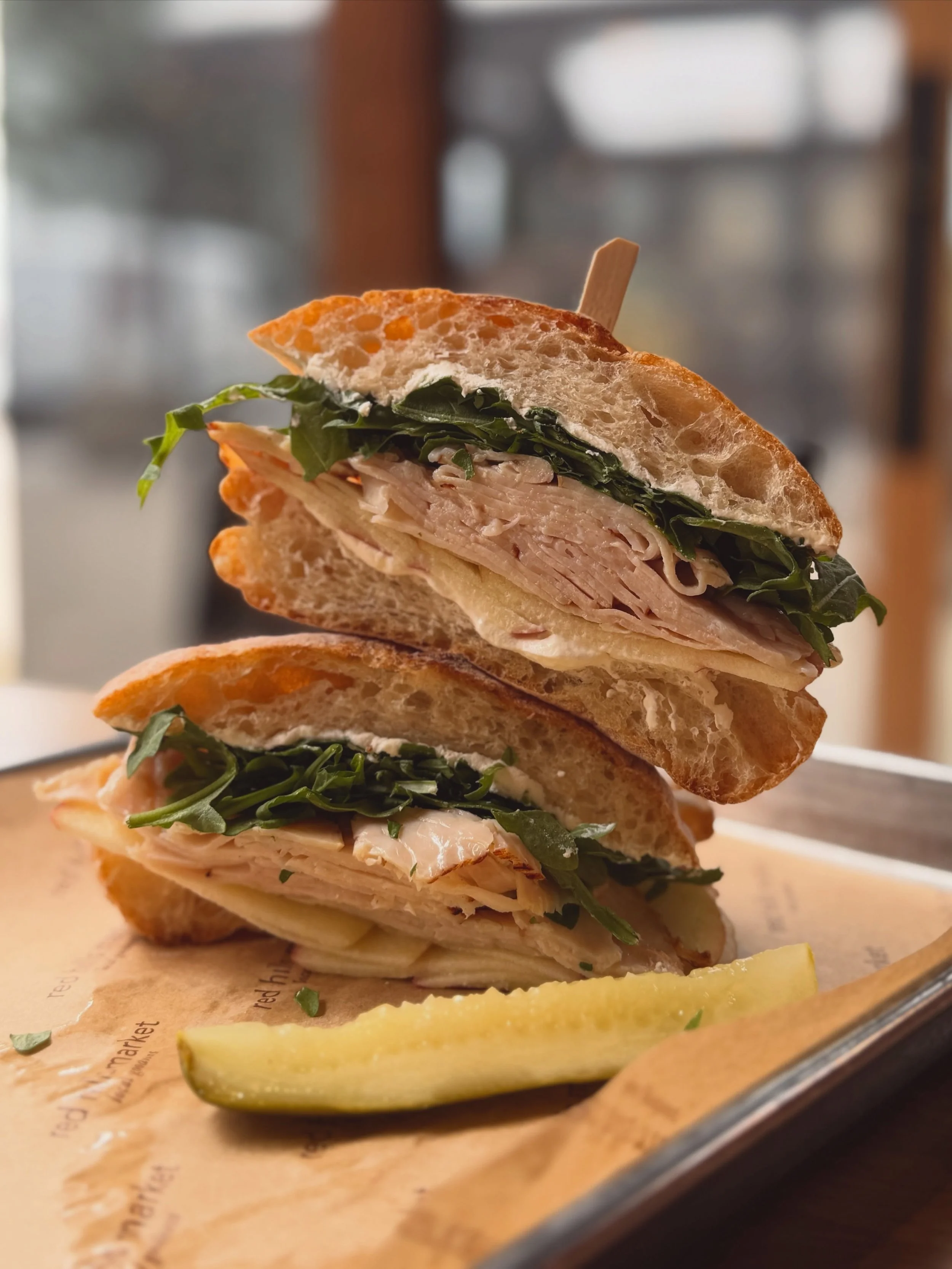 A longtime fan favorite our rhm turkey sandwich! Layered with cream cheese, crisp sliced apple, arugula, and our house burnt orange vinaigrette on daily house made ciabatta.