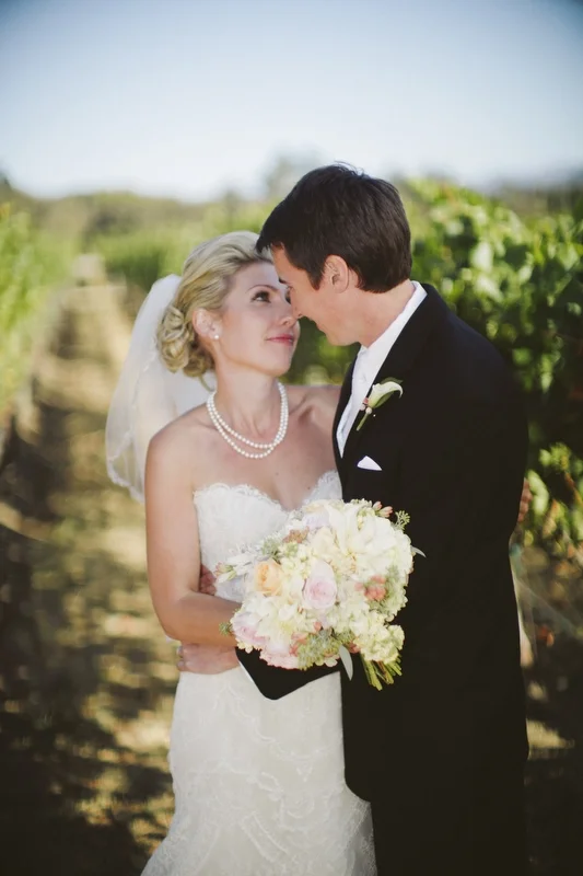 Set amidst the Vineyards at Bernardus Lodge and Spa in Carmel Valley.  Th e wedding couple has a moment.