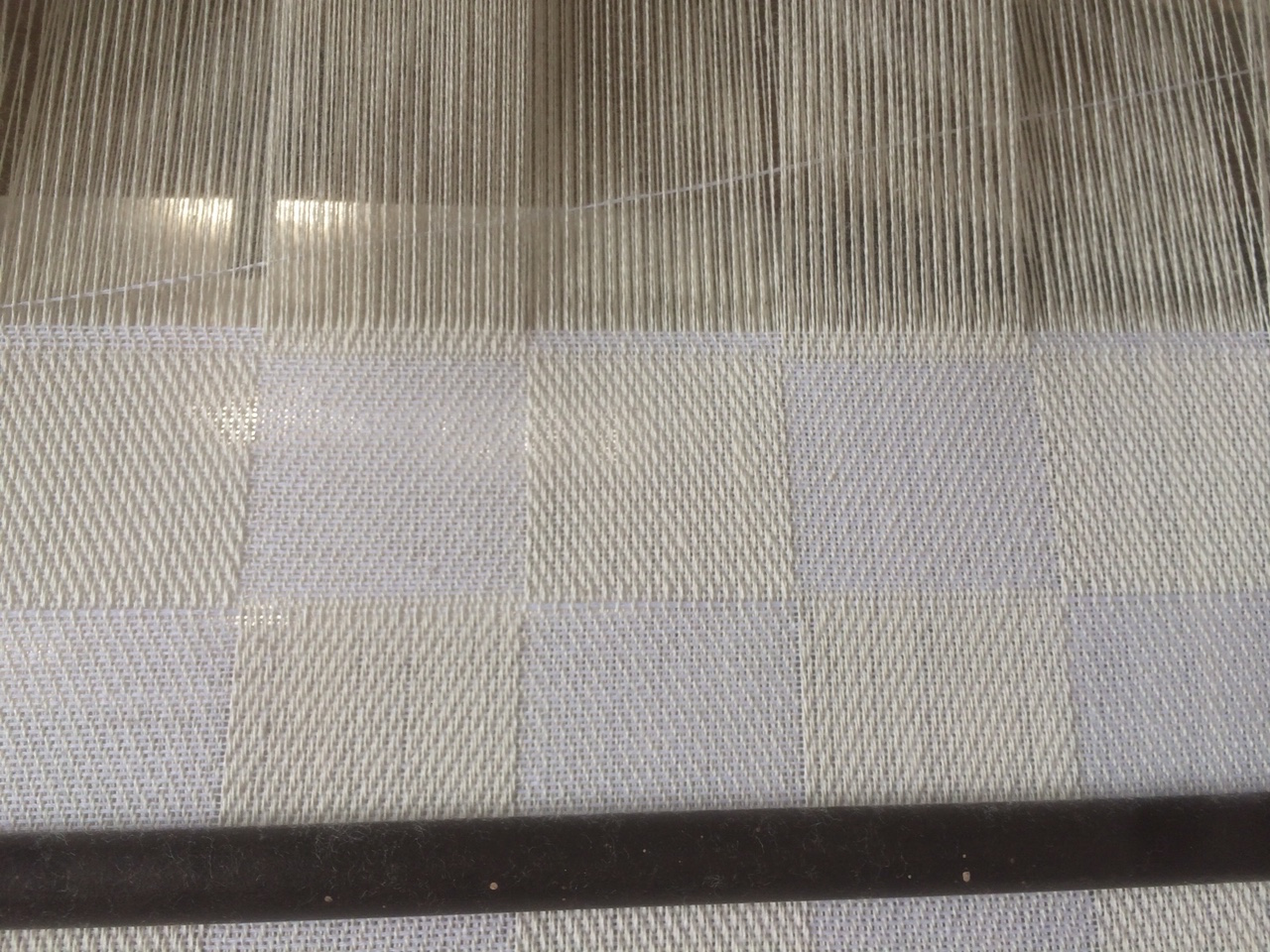 Checker detail. Due to the nature of the looming process, tolerance was given to each square's measurement.