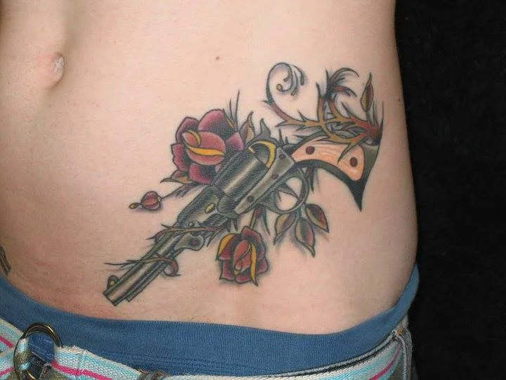 gun-tattoo-hip-apple-tattoo-rochester-new-york.jpg