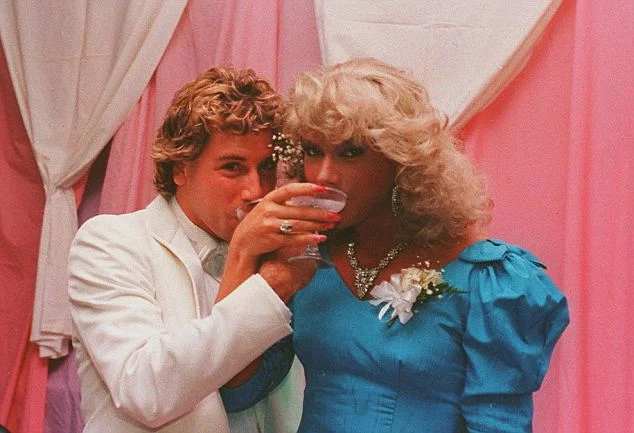 John, wearing the blue dress on the right, in a transgender lifestyle.