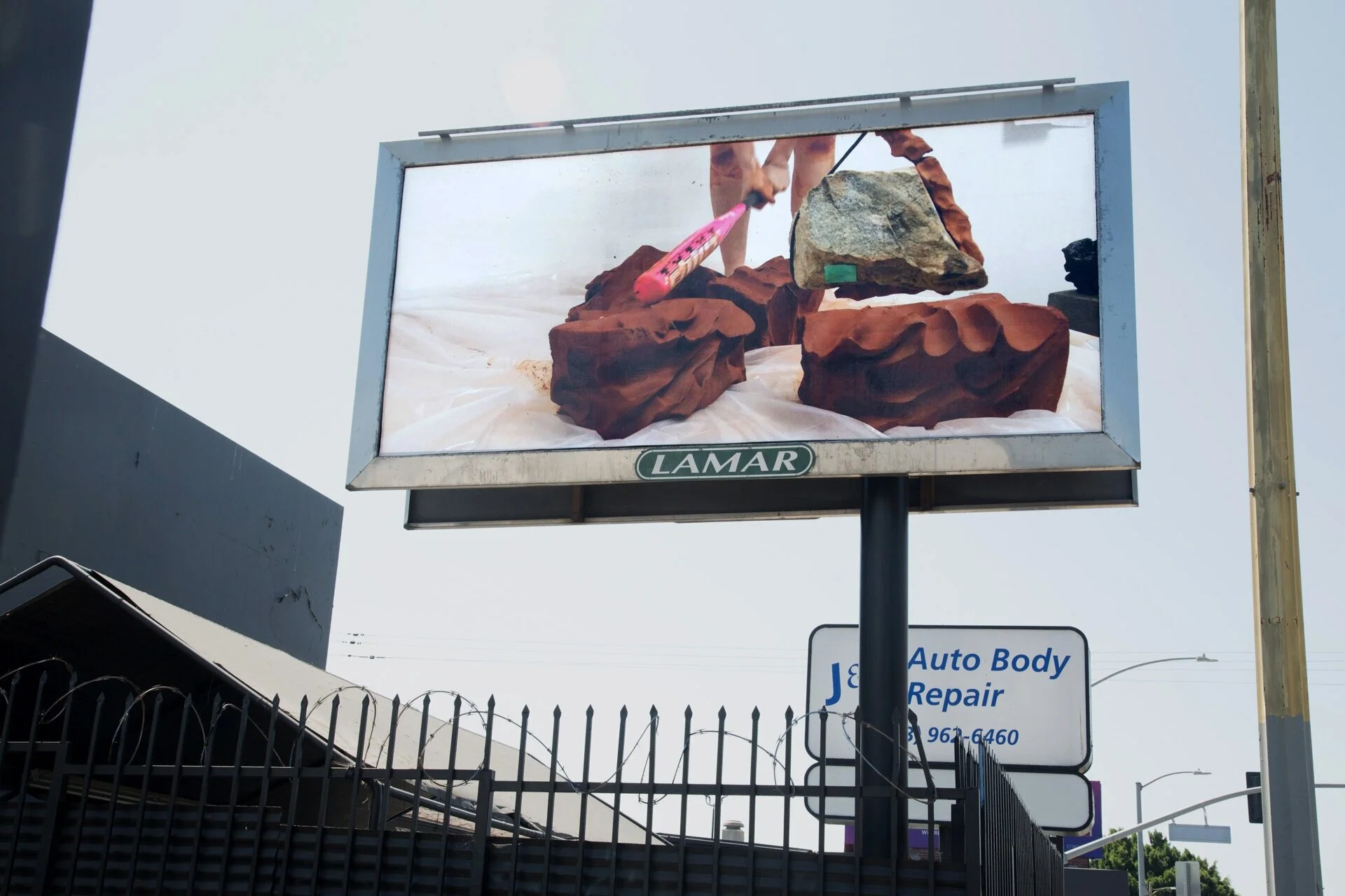   we didn’t want to be moved, 2020  Performance and installation composed of: combined weight of artist and their mother in raw clay (280 lbs), hot pink baseball bat, rock from largest dam in California, plastic drop-cloth, and wooden platform.  Exh