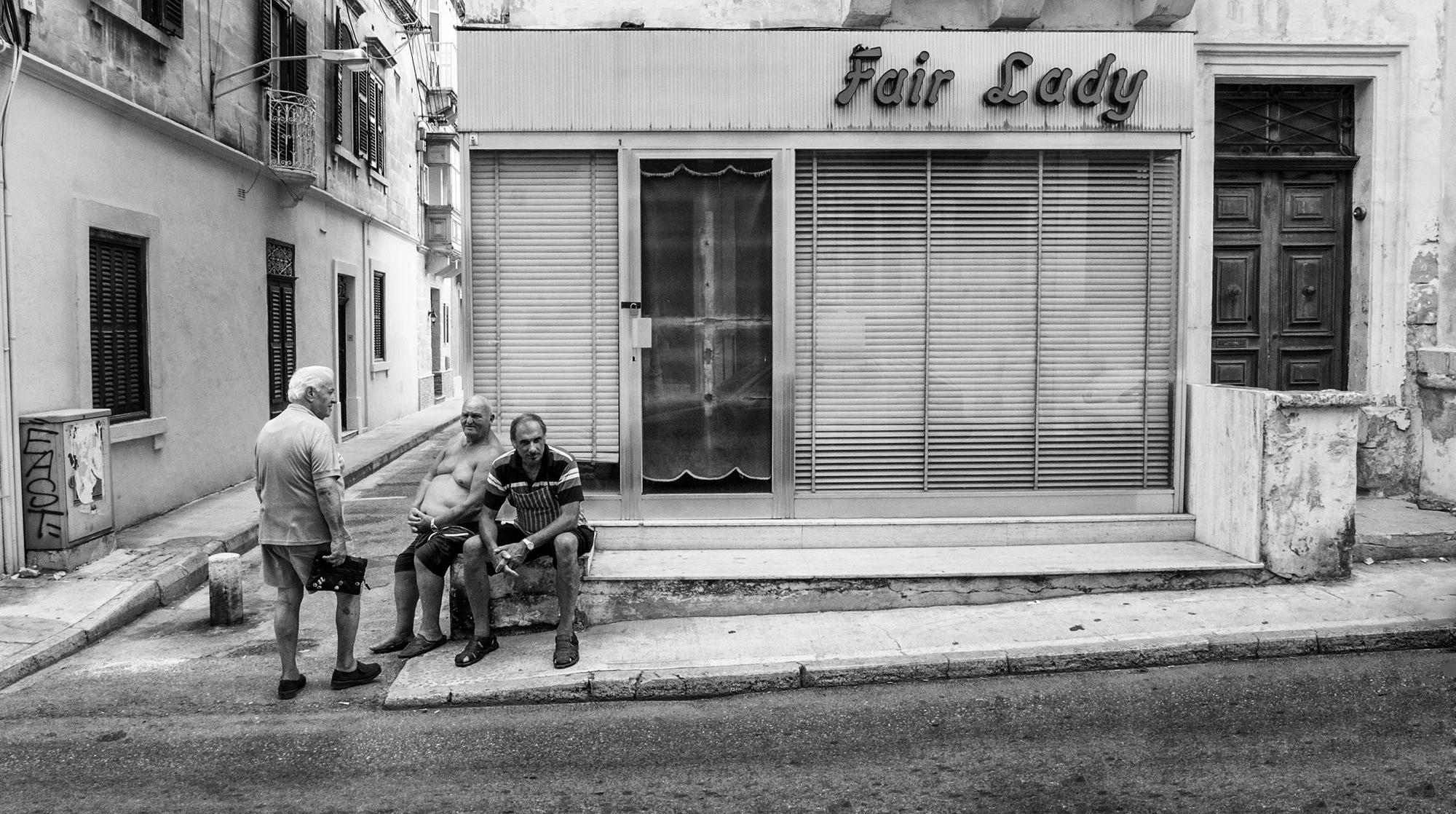 Peter who sits on Sunny's left side facing the camera is the butcher who runs the shop opposite the Fair Lady. He is always ready with a smile when he sees me.