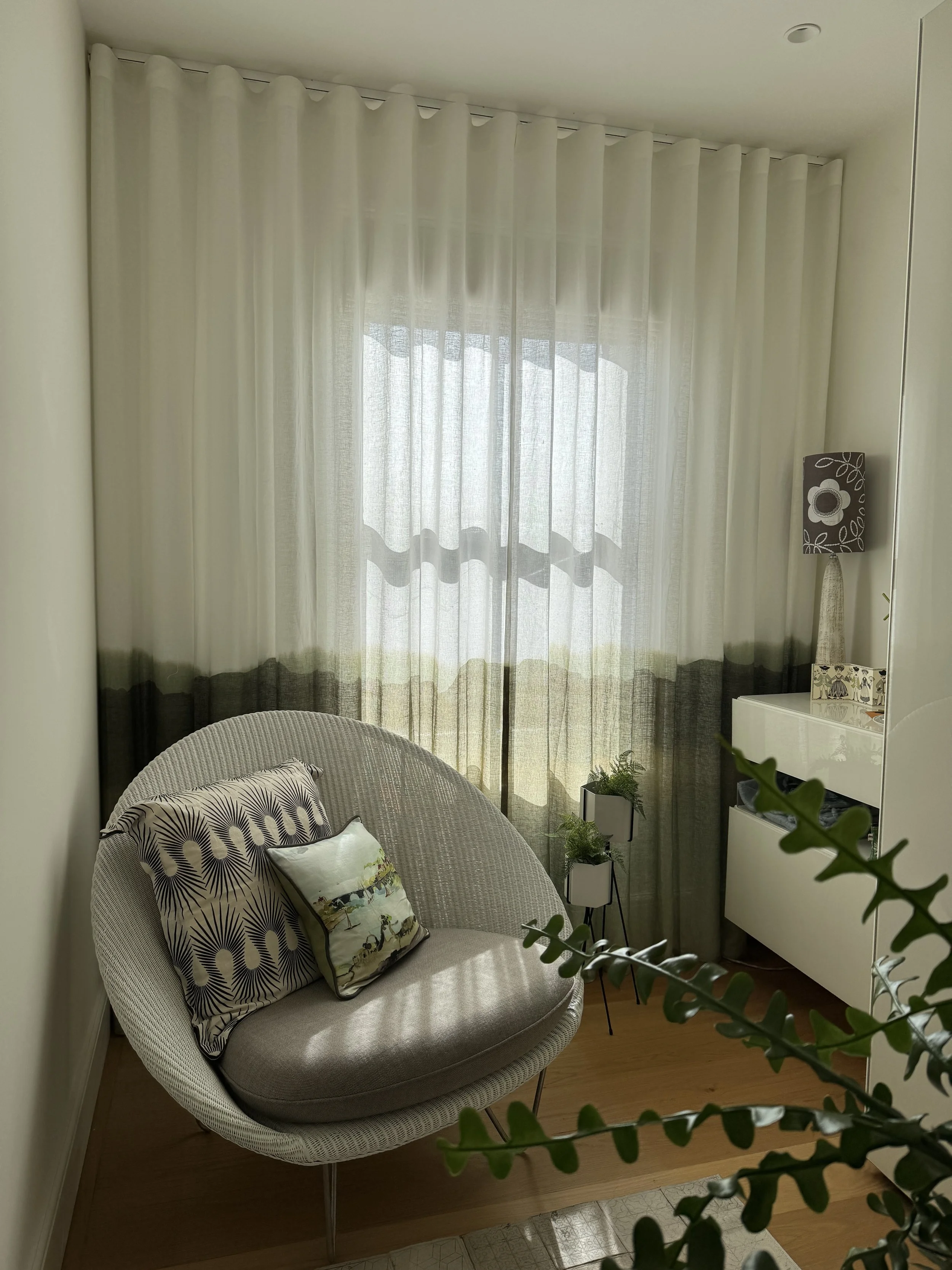Dressing room with floor-to-ceiling sheer curtains in Casamance Haze fabric on a wave heading.