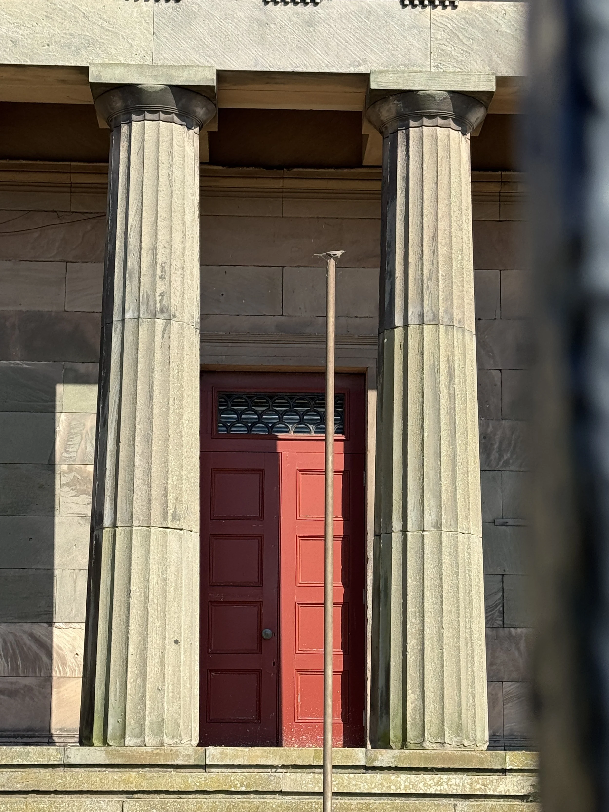 Stone columns and red door at the Oratory, Liverpool