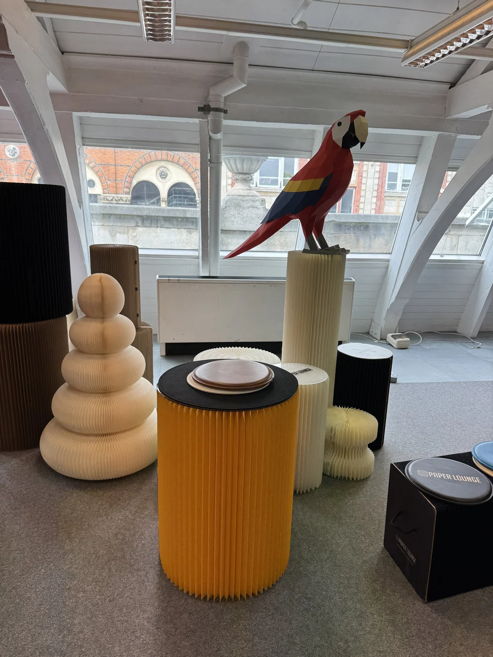 Paper Lounge, and ingenious corrugated paper seating and tables and parrot.