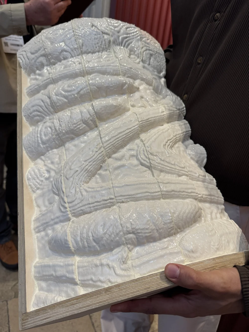 Ceramic organic tile crafted from reclaimed London clay.