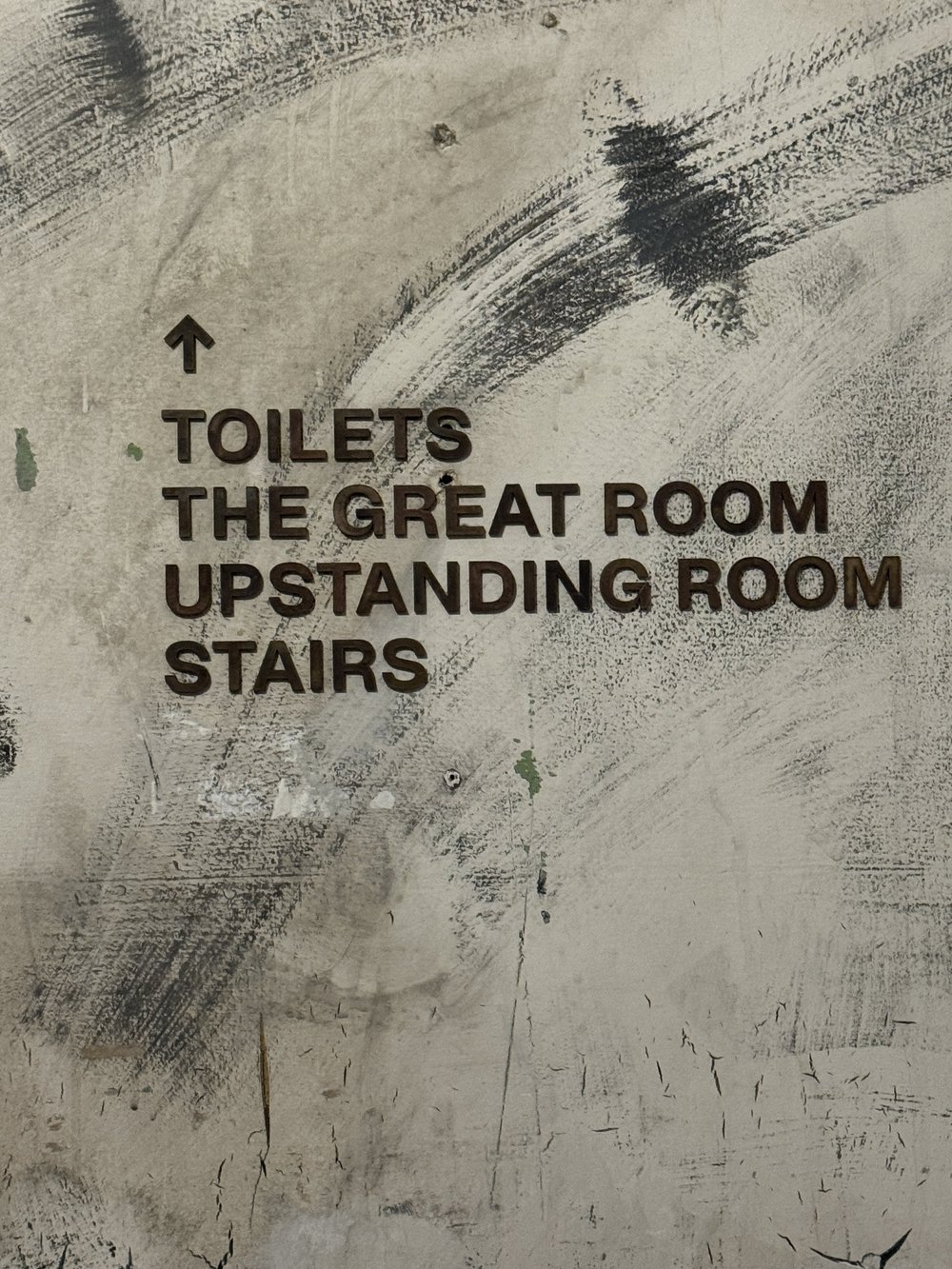 The Great Room direction graphics on distressed wall