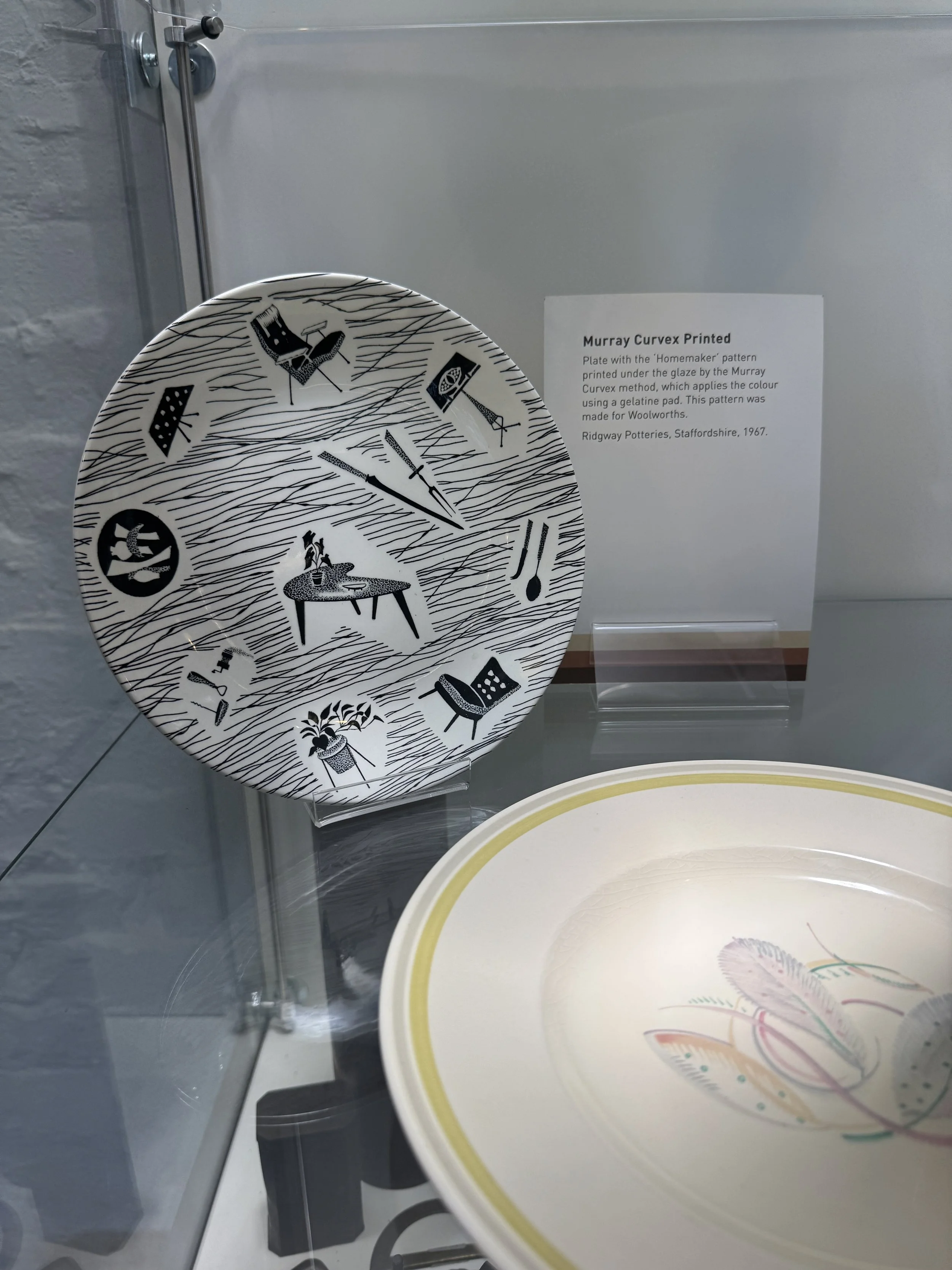 Mid century patterned plates in a museum display case, Gladstone Pottery Museum