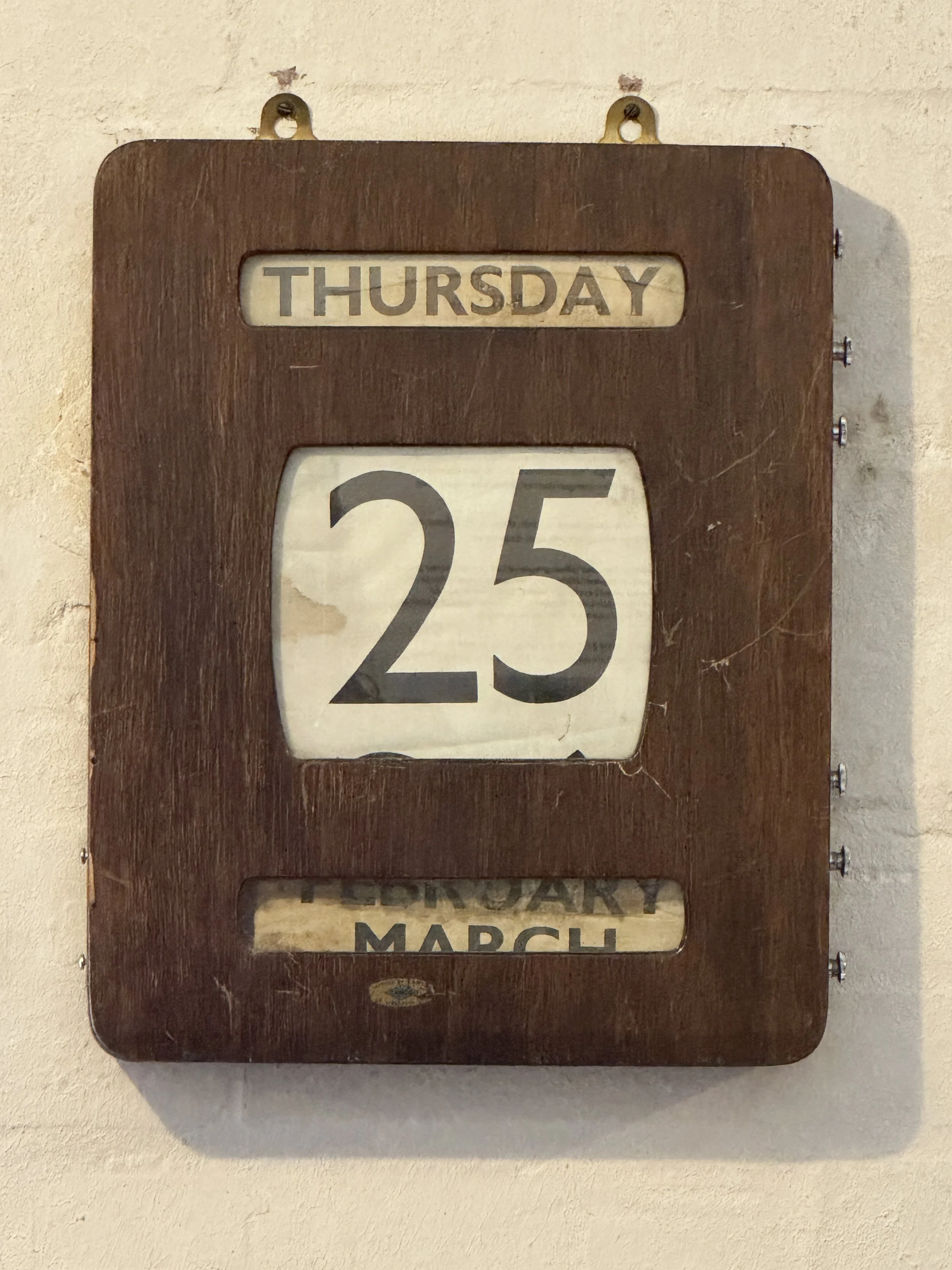 Vintage wooden day and date calendar on a workshop wall, Gladstone Pottery Museum