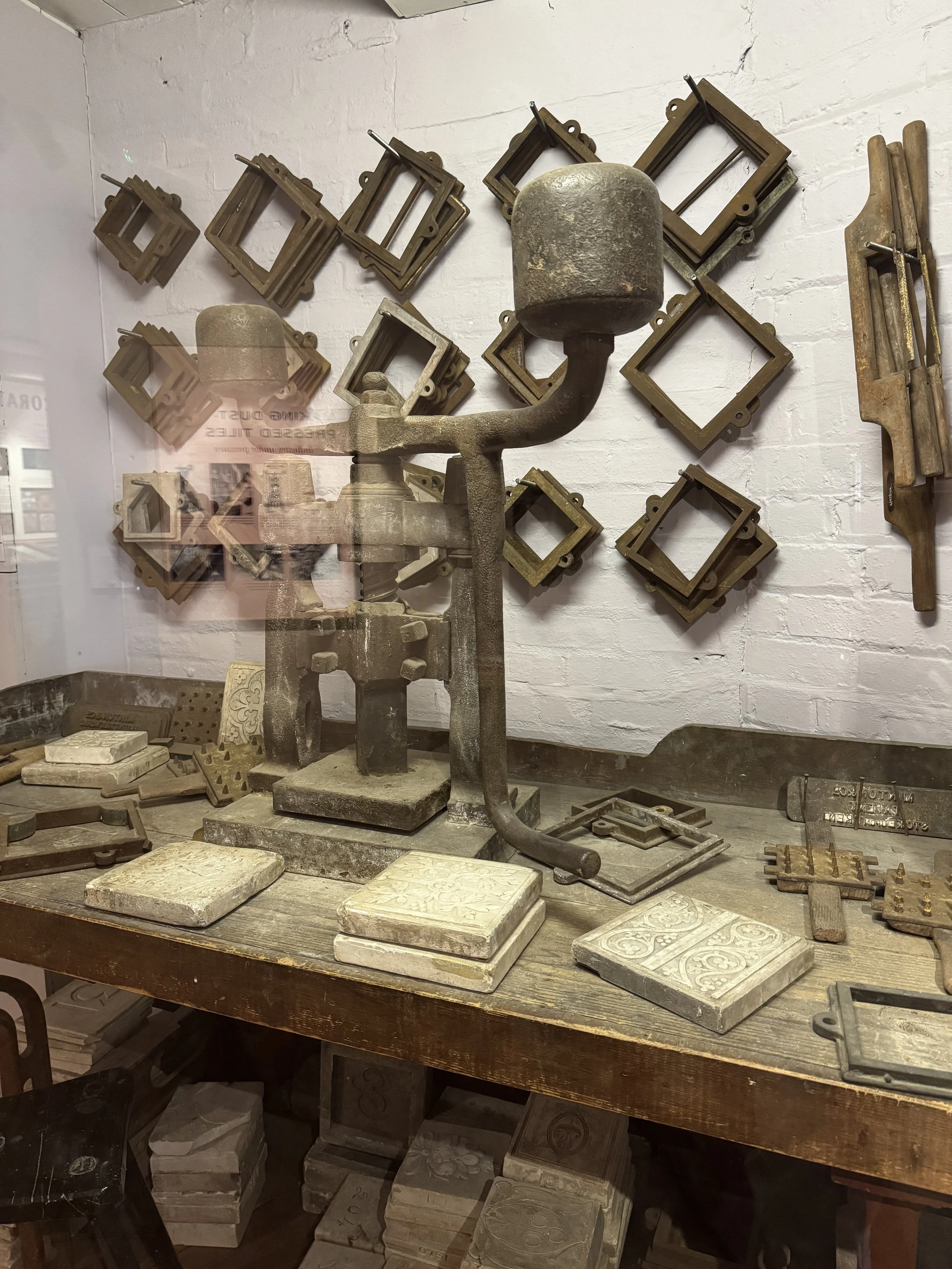 Tile press and wooden tile moulds on a workbench, Gladstone Pottery Museum