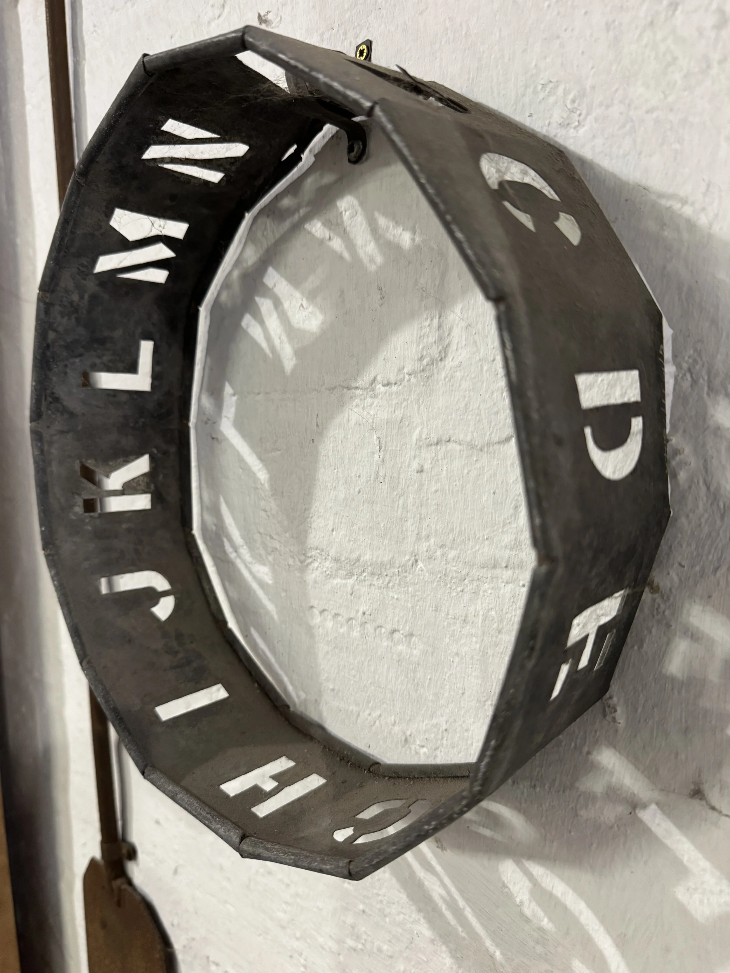 Metal letter stencil ring on a workshop wall, Gladstone Pottery Museum