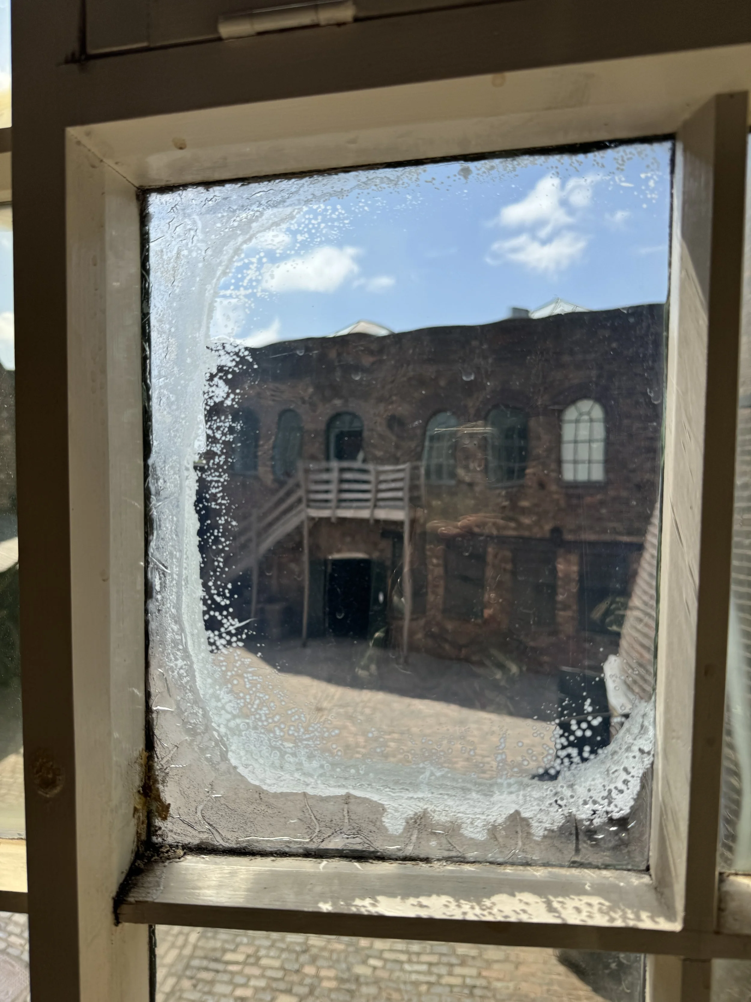 Courtyard seen through an old frosted window pane, Gladstone Pottery Museum