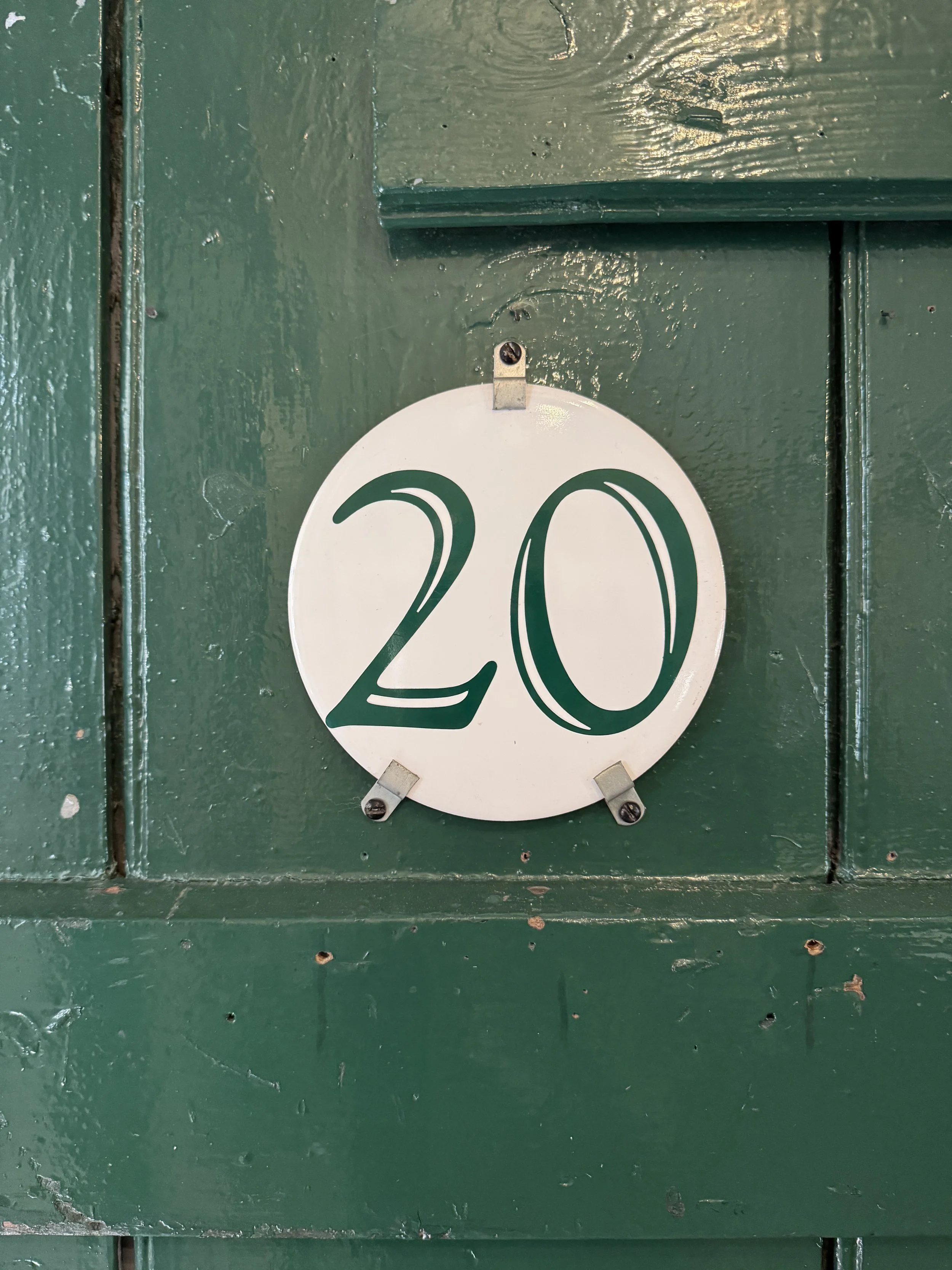 Green workshop door with a number 20 plaque, Gladstone Pottery Museum