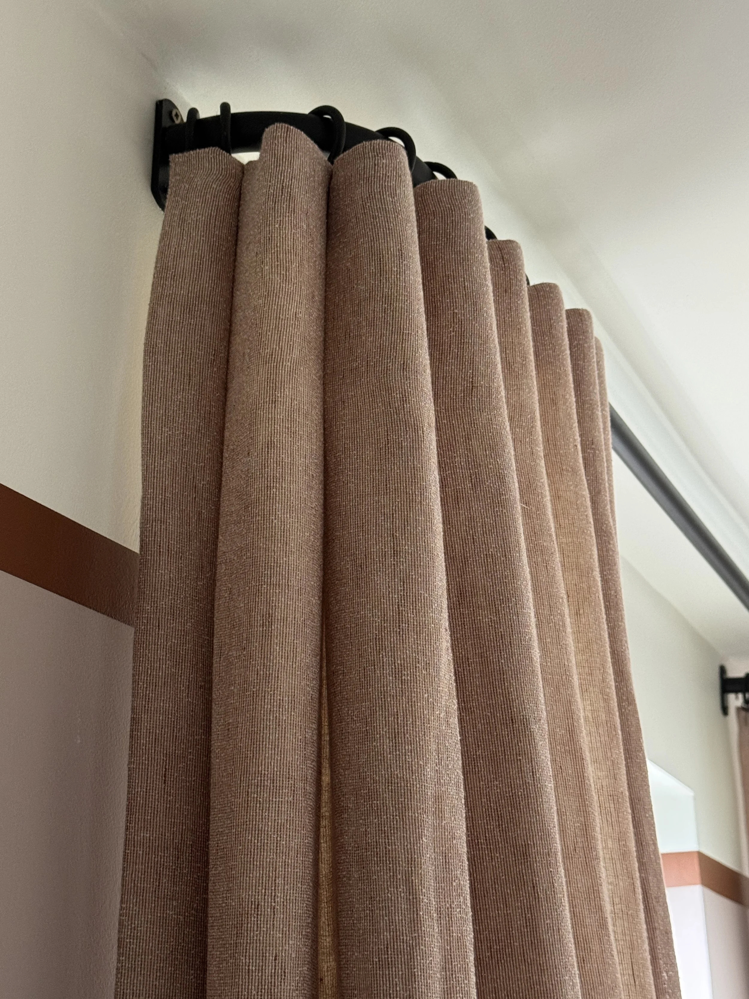  Bespoke lined curtain with an inverted pleat heading on a black French pole, installed close to the ceiling to emphasise height and enhance the proportions of the room. 