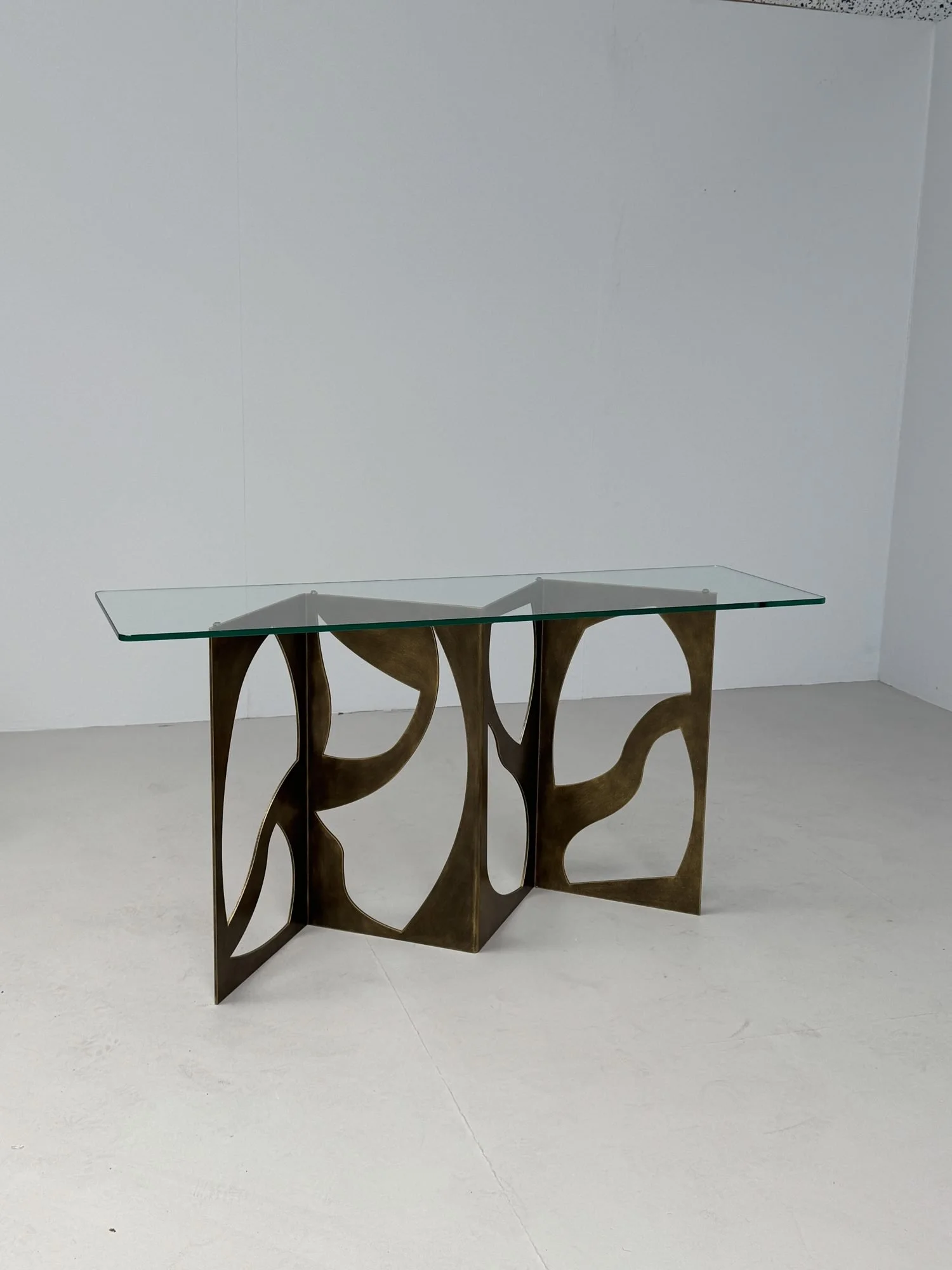 Eclipse console with a glass top in antique bronze