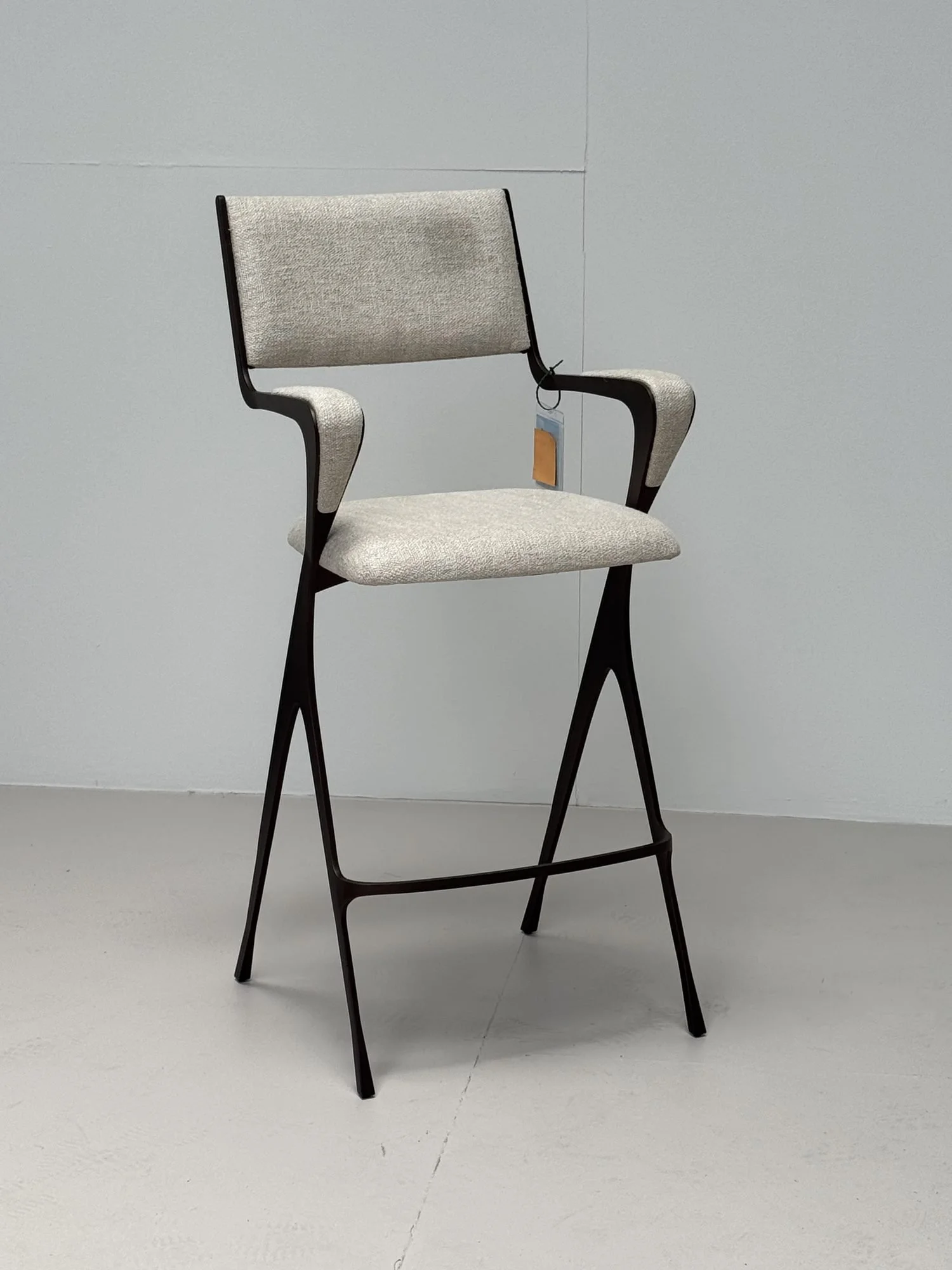 Upholstered bar stool with a bronze frame