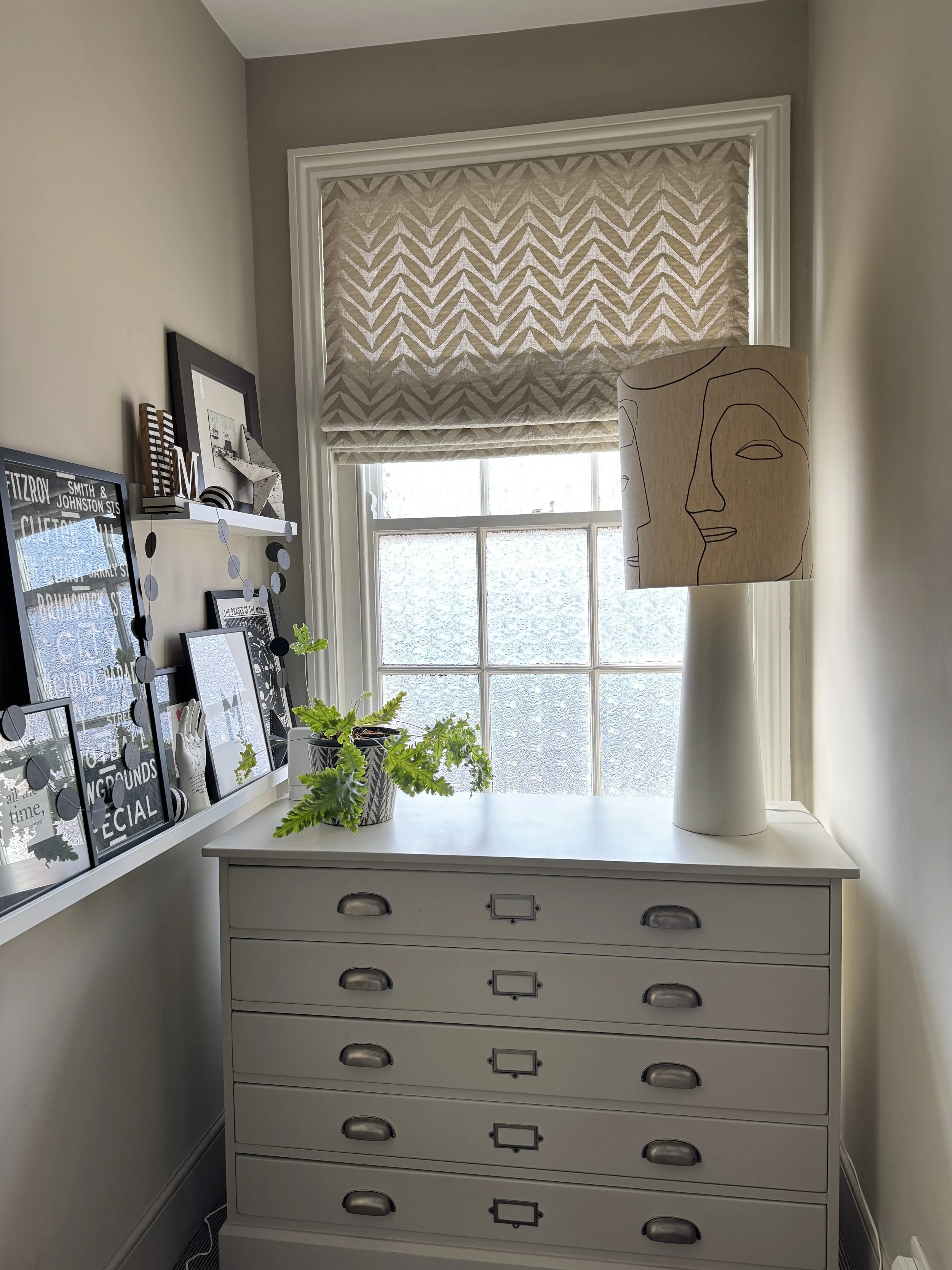 Roman blind in contemporary appliqué fabric by Jim Dickens fitted inside an Edwardian sash window on a landing in a Devon home.