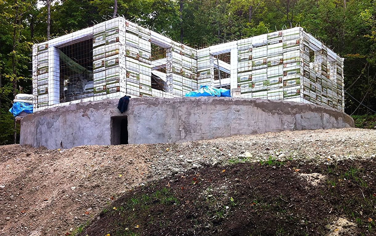 The Information House... commonly available pre baled blocks of off the shelf WASTE " cellulose insulation " 
