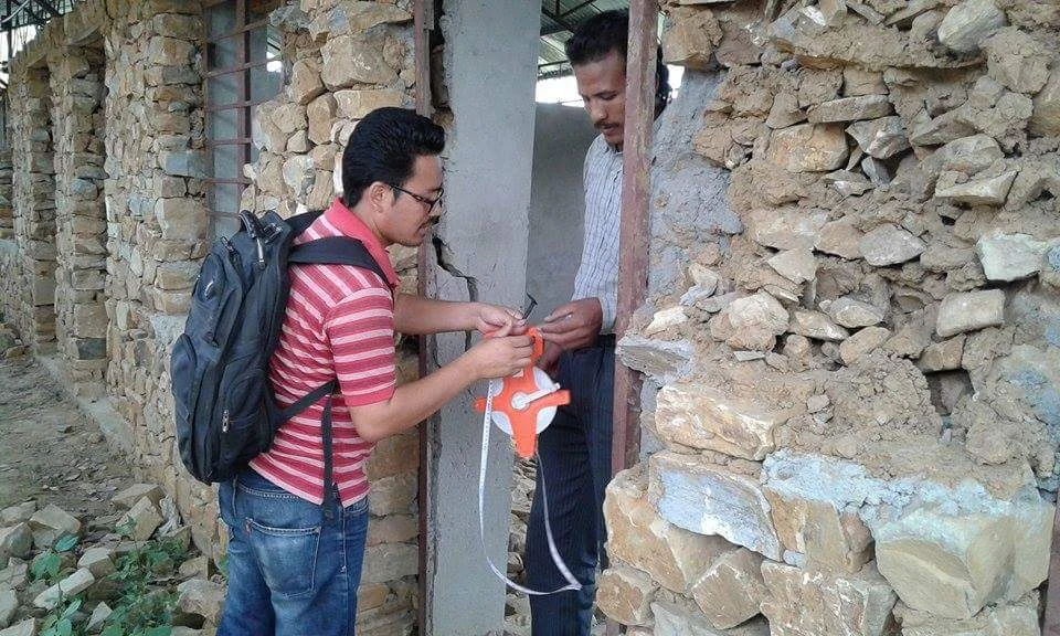 An engineer at work, planning how to rebuild the lost sections of Man’s school.