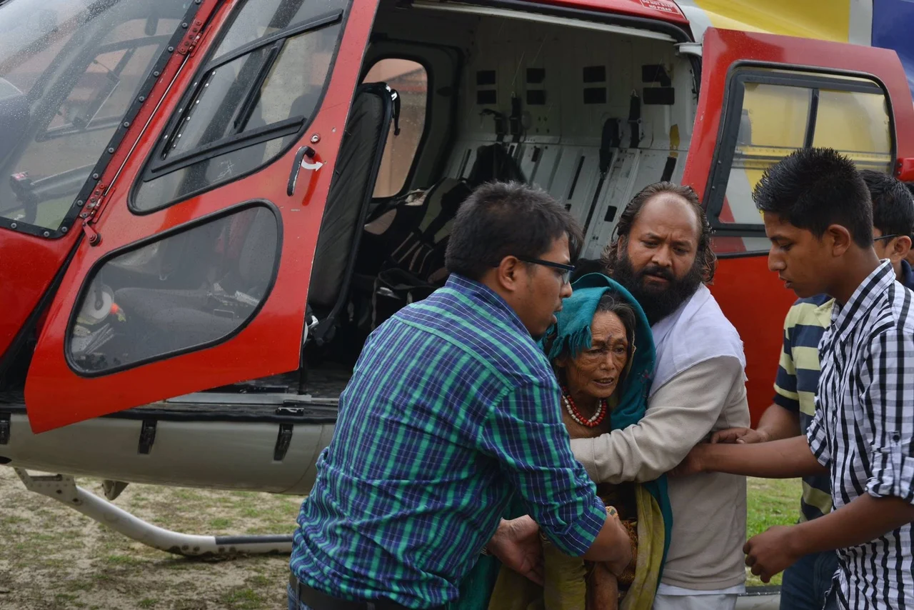 The CYF Collective's first helicopter rescue mission transported Furke Lama, age 55, from Dhap, Sindhupalchowk to the Dhulikhel Hospital. Her multiple injuries included a rib bone fracture, deep forearm wound, possible sepsis, and a severe chest infection. This rescue mission, led by Dr. Sajal Shakya, Dr. Roshan Piya, and Prajwan Shrestha, also airlifted two others to the hospital. During the same trip, they dropped 350 kilos of relief items to Gunsa, Sindhupalchowk as well. This helicopter trip was funded by our friend Marie Claire in France.