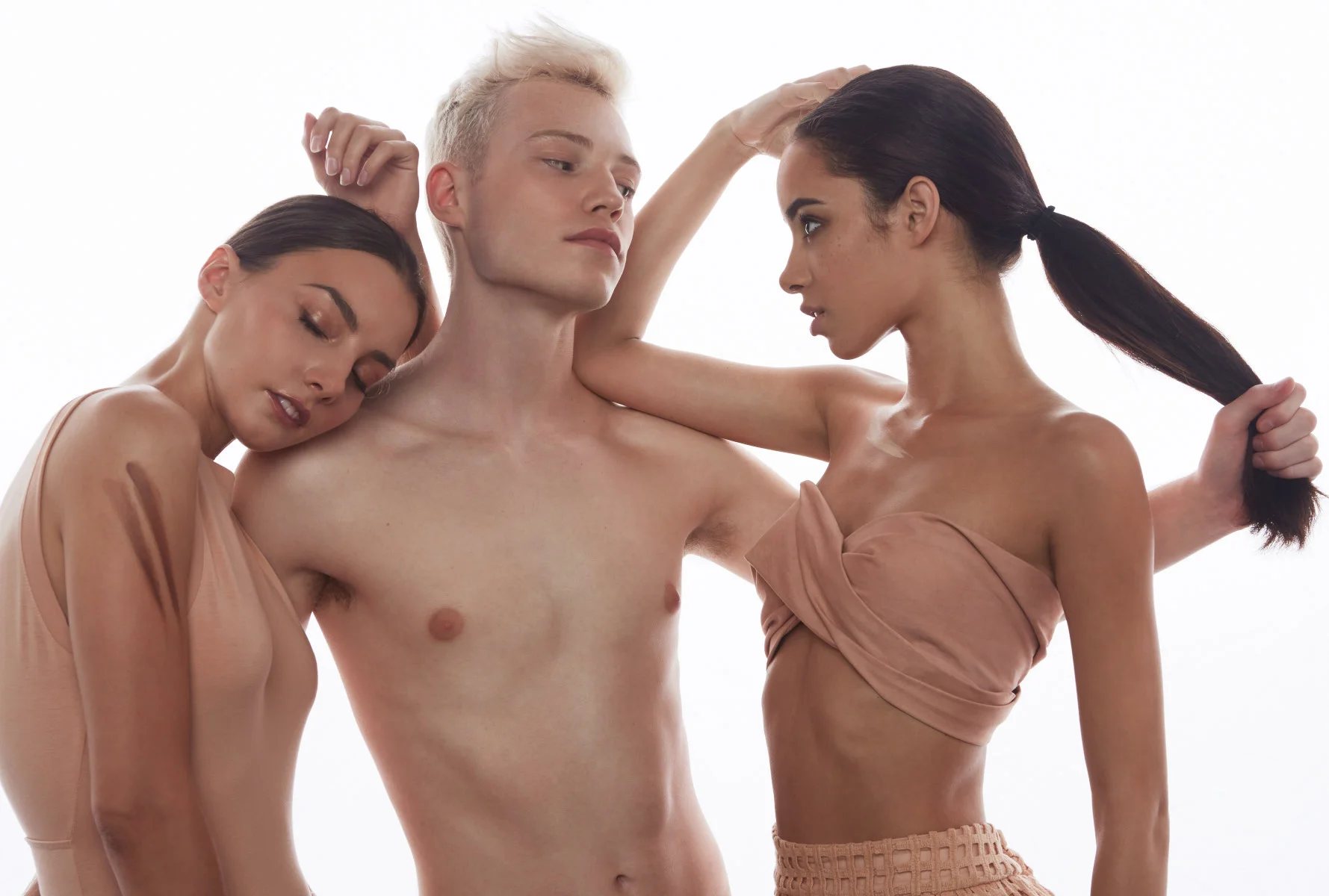 Out-take from ombre of nudes fashion shoot. Three models, one male, two female, from the fair skinned end of the gradation embrace in a dramatic pose. Team credits: Wardrobe: Kathryn Switzer Hair and Makeup: Brielle Brenner Post production by Renée Aylworth and Leah Perry Photography